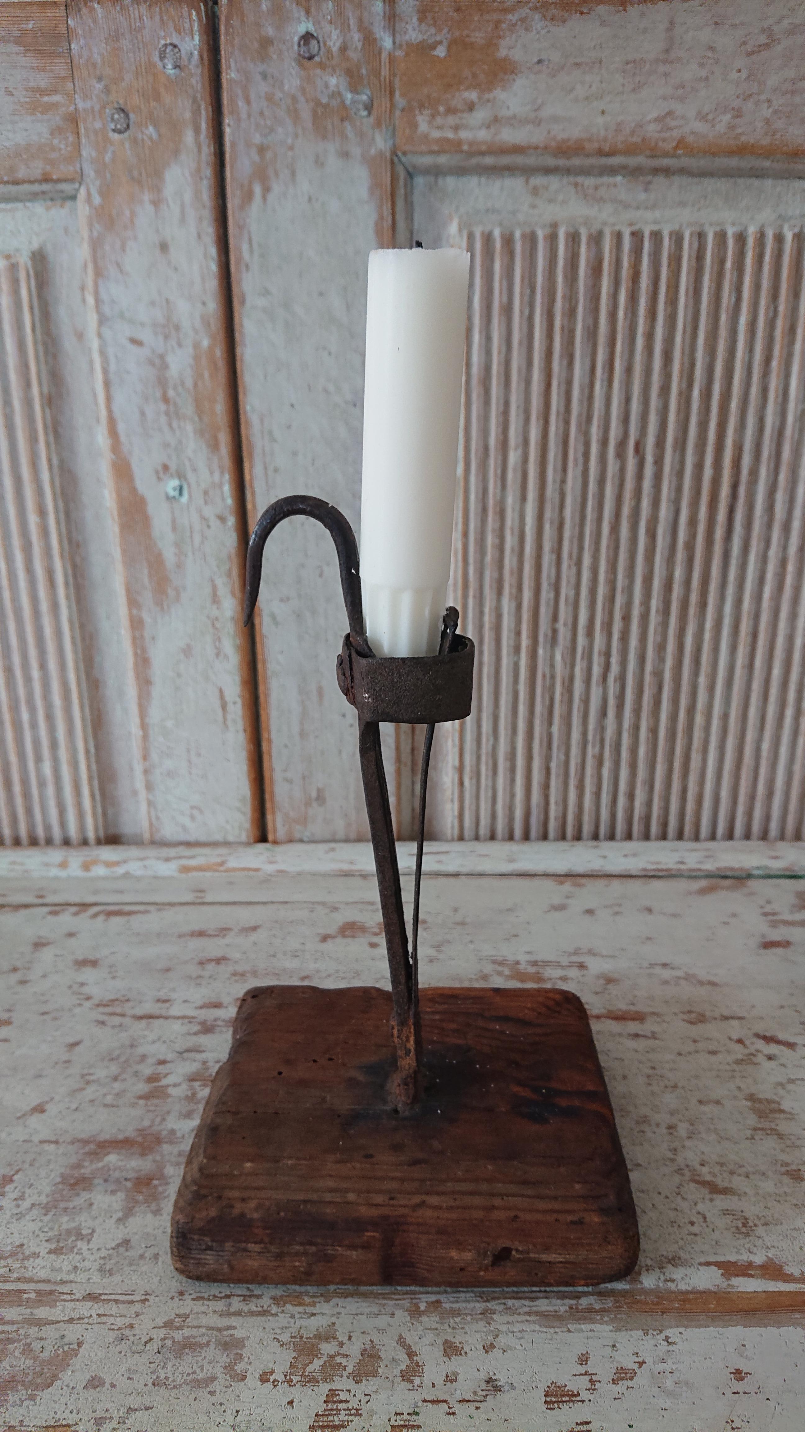 An old antique Swedish 18th century iron candlestick with the foot made of wood.
Very charming & solid.
This candlestick is called 