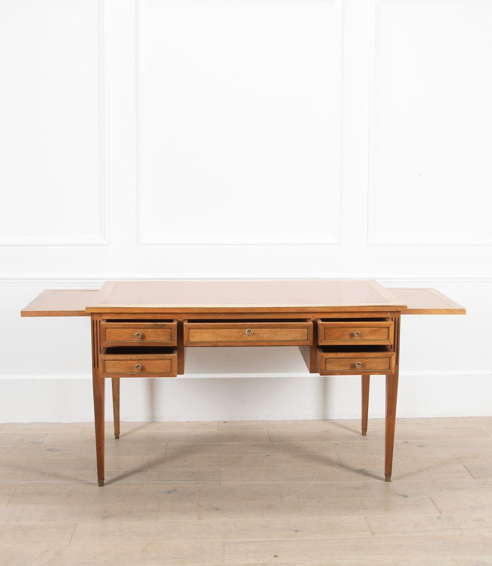 An early 20th Century French Bureau Plat or desk with drawers and leather inset.

In addition the desk has a slide either side which can be extended for additional work space and hidden away when not in use.
