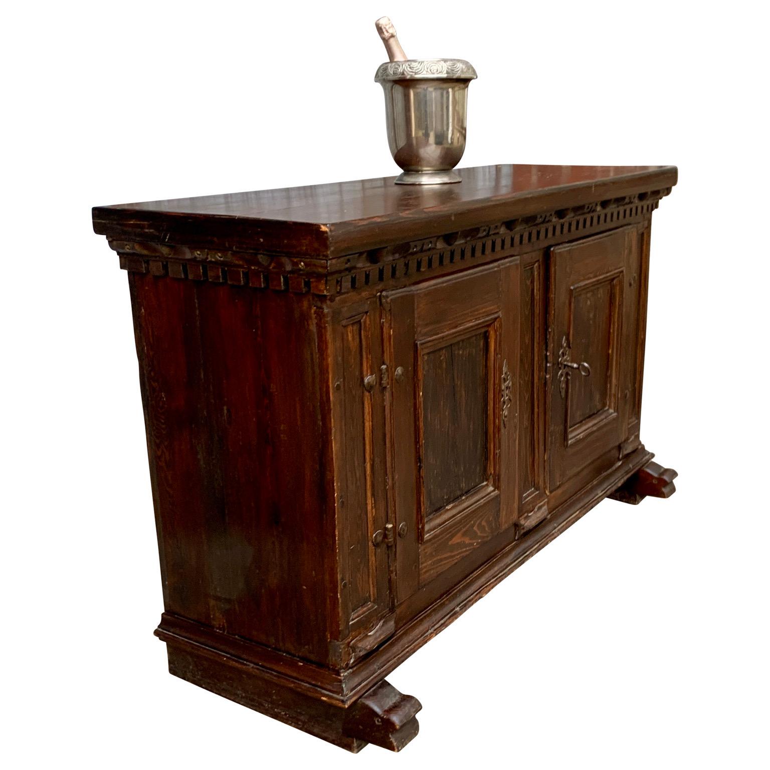 A period style Baroque early 18th Century baroque cupboard in dark patinated pine wood. The clean and useful interior is of a later date and features two drawers that can be used for cutlery. The drawers open effortlessly. For its low height 90.5 cm