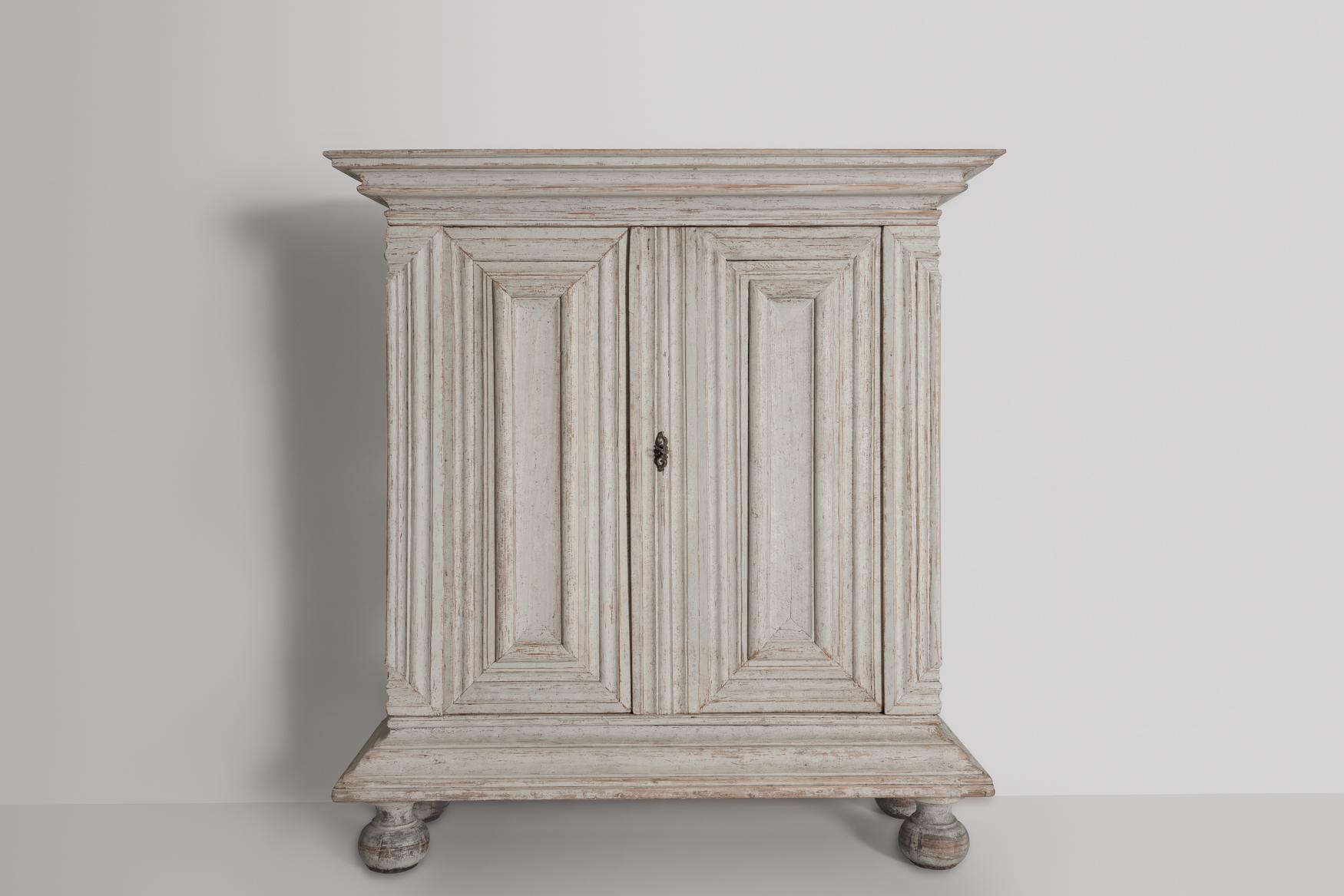 A fabulous Swedish baroque period cabinet from the 18th century, circa 1760 in later, not original, paint. The large doors sit above a single drawer and open to reveal two removable, internal shelves. This is a fabulous piece with plenty of storage.