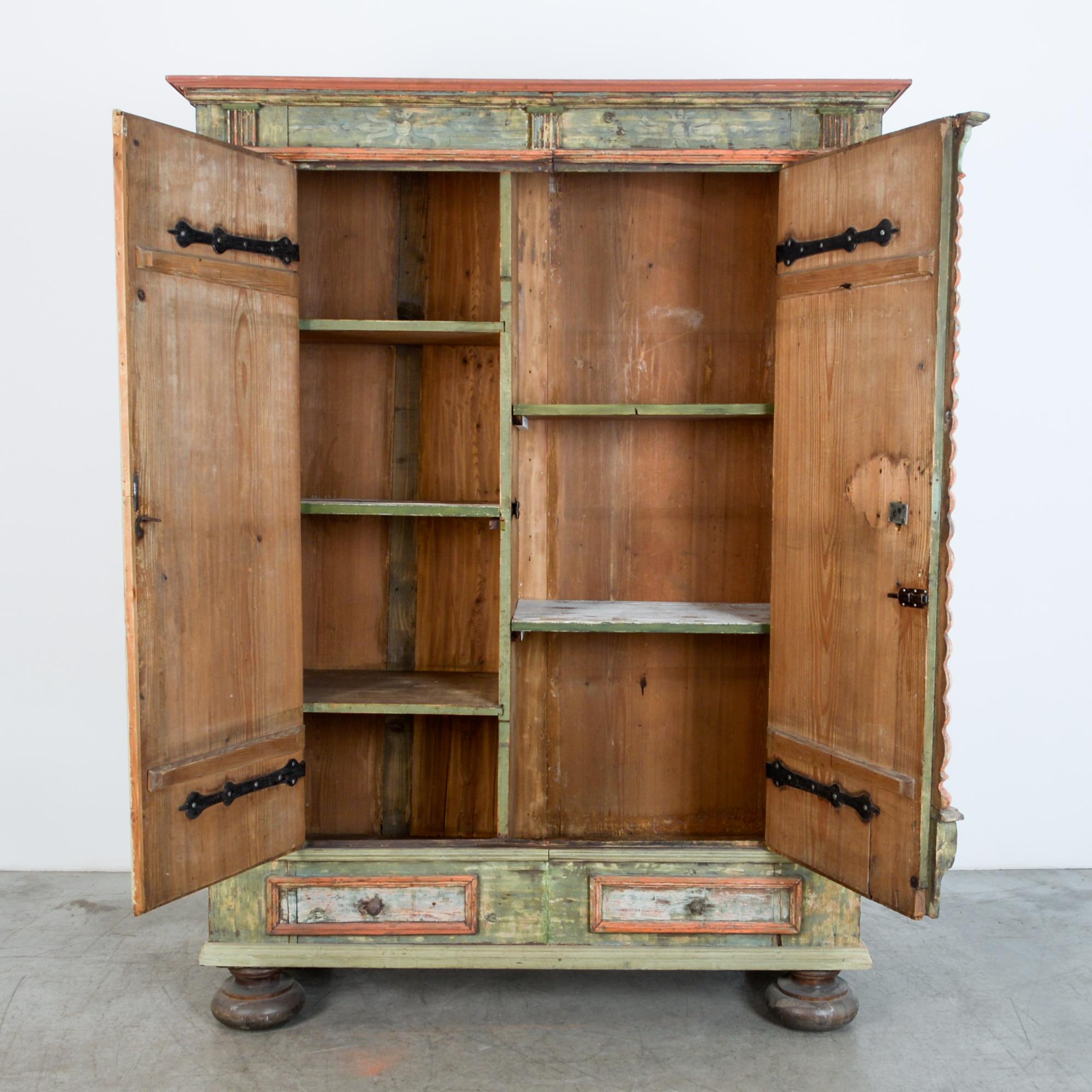 This tall wardrobe or storage cabinet is from Sweden, circa 1780. Adorned with distinctive architectural ornaments, beautiful textured patina, and resting on sturdy turned legs. This is a truly unique piece, brightly painted, with all original
