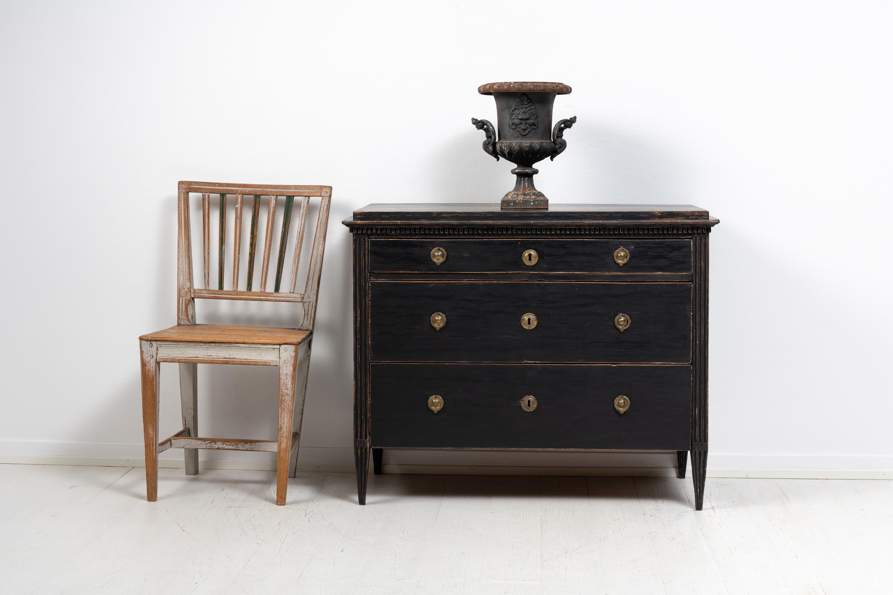 Gustavian black bureau from Sweden made during the last years of the 18th century, around 1790 to 1800. Made in painted pine where the paint has distress and patina causing the pine to shine trough in places. The bureau has straight tapered legs and