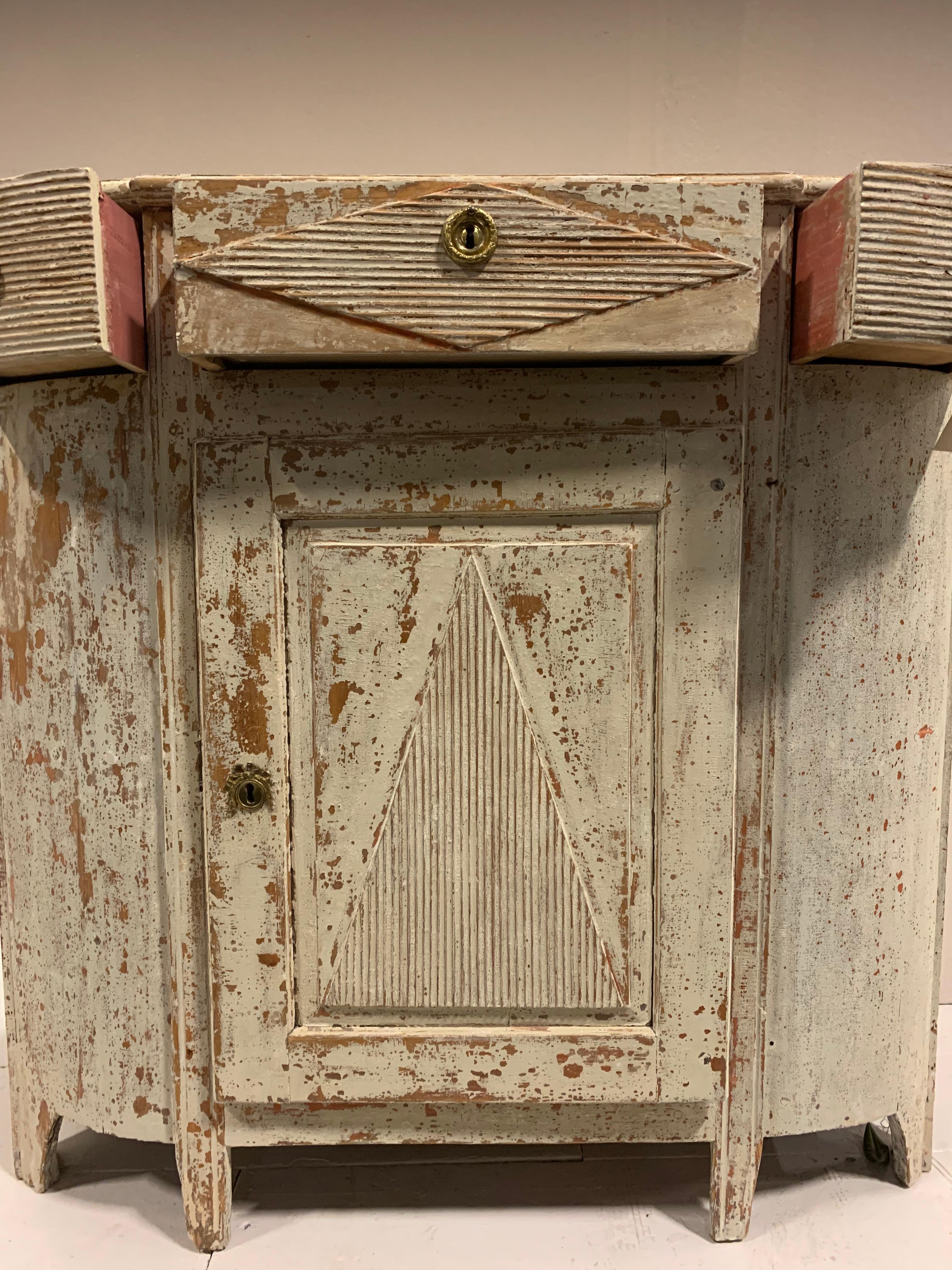 Late 18th century painted Swedish buffet, with central door with a triangular reeded design, sitting below three drawers of similar decoration.
The exterior has been hand scraped to a pale colour but the interior is in lovely original pink with a