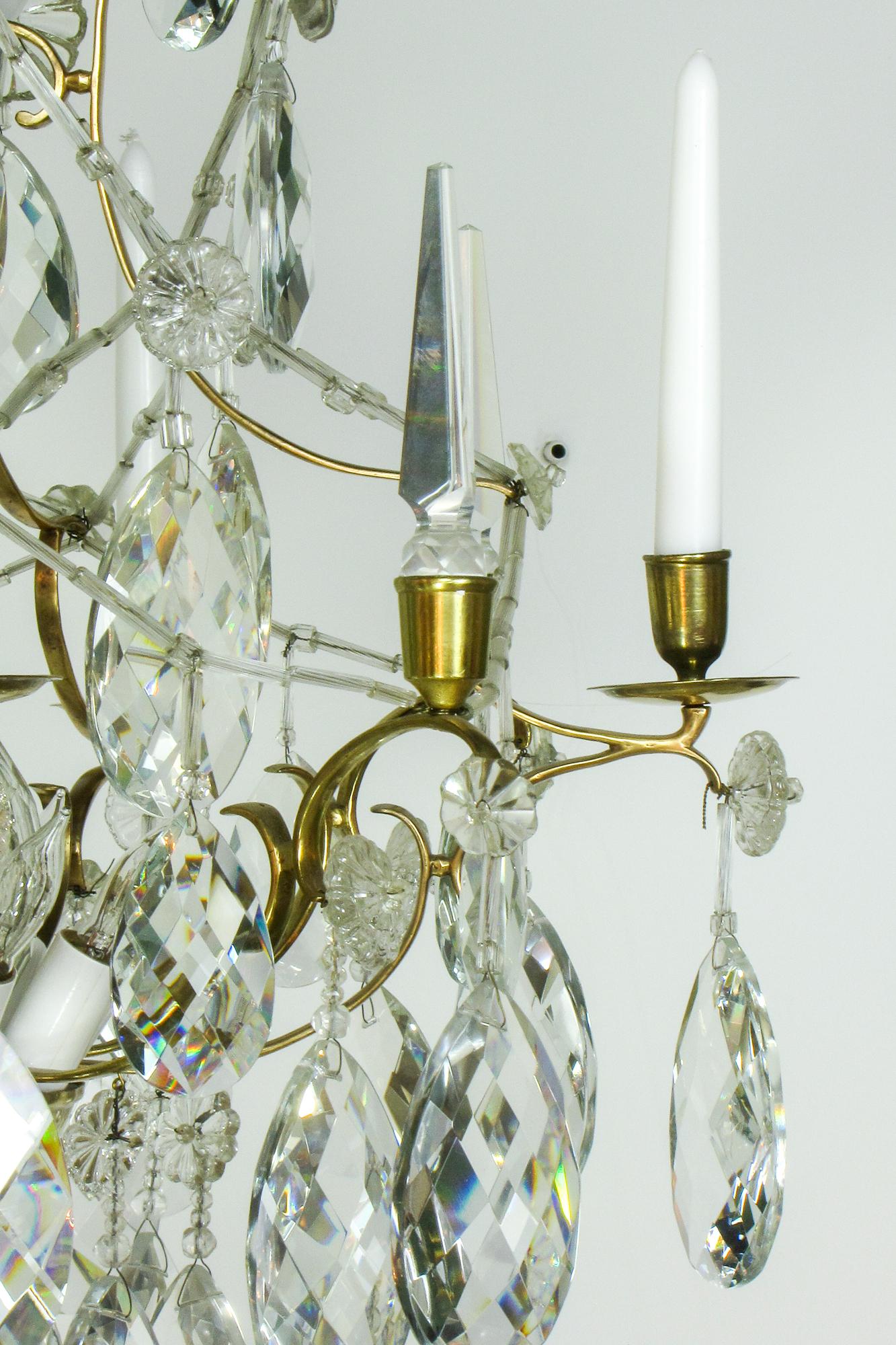 A dazzling crystal chandelier typical of 18th Century Sweden.  The chandelier has a delicate brass frame likely made in france then imported to Sweden for crystals.  The crystals are large swedish cut with oversized crystal ball stem pieces and