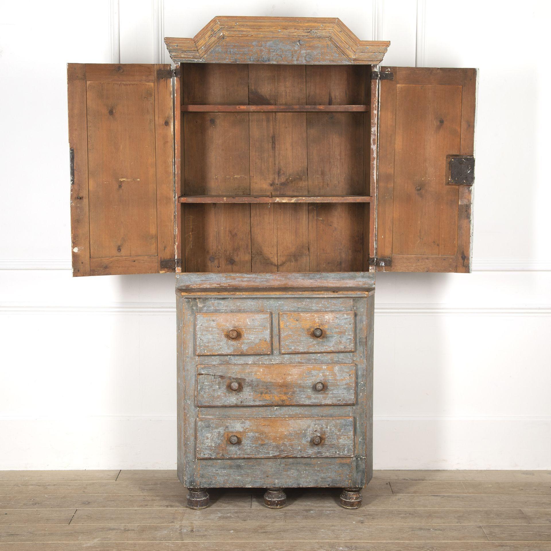 Exceptional Swedish 18th Century cabinet in its untouched and original paintwork.This superb piece features a wonderfully carved pediment that sits above two beautiful doors that are etched with floral details throughout. The two doors open to