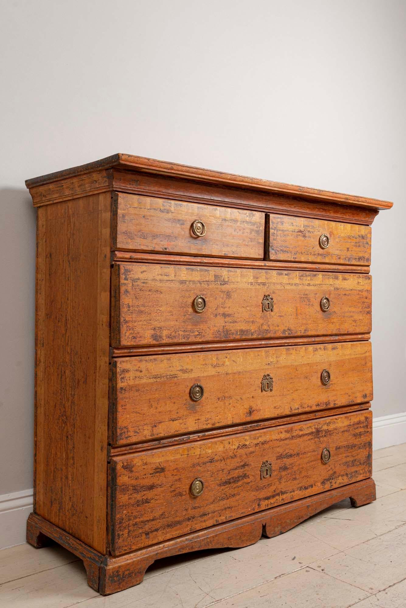 Swedish commode or chest of drawers known as a 'folk chest' which is from the northern region of Sweden, circa 18th century. A beautiful piece with a simple and understated design but full of character. It has its original hardware and also retains