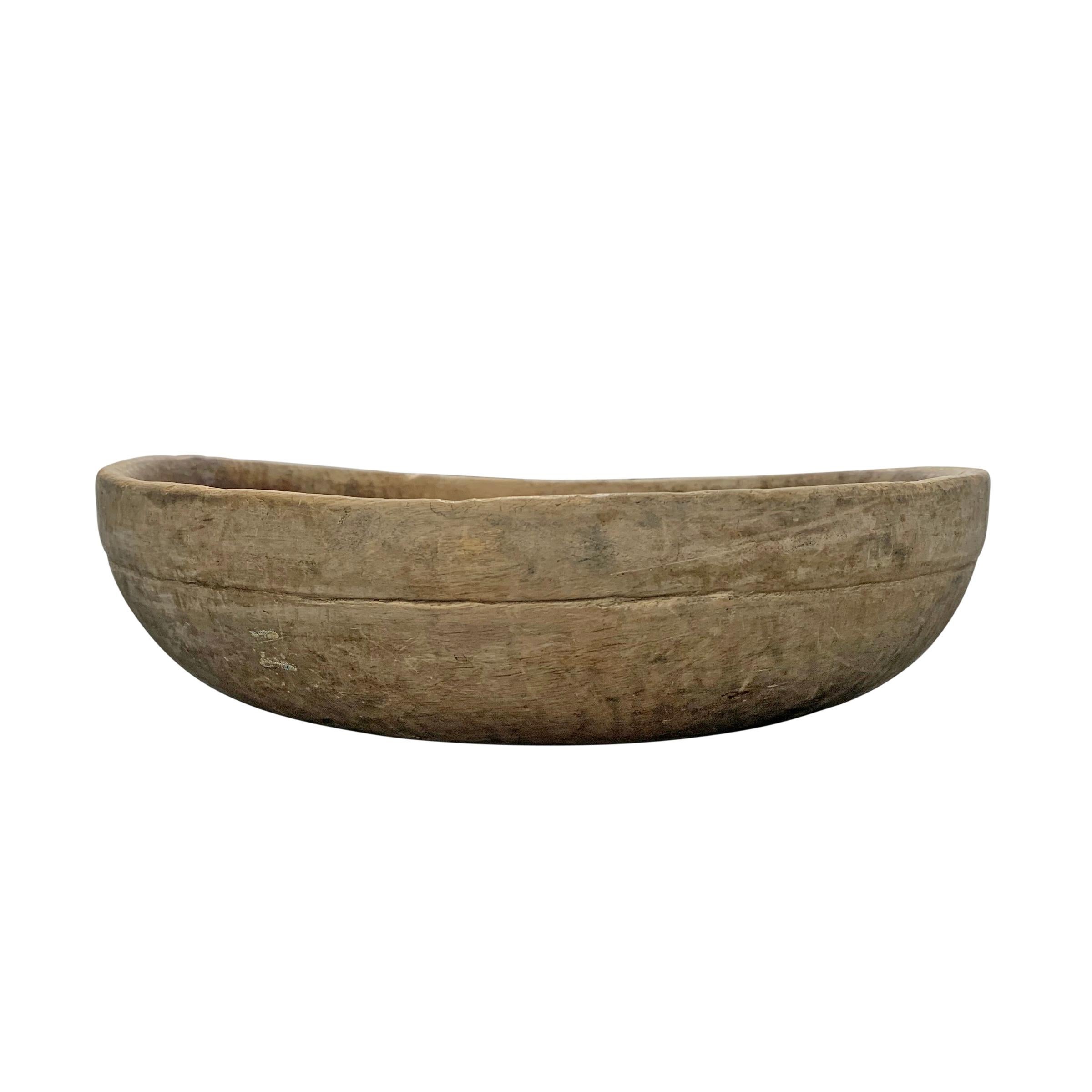 A fantastic 18th century Swedish turned wood dairy bowl with an amazing dark patinated interior and a soft greyed exterior with an incised line around the rim. An old crack serves to remind us of its storied past.