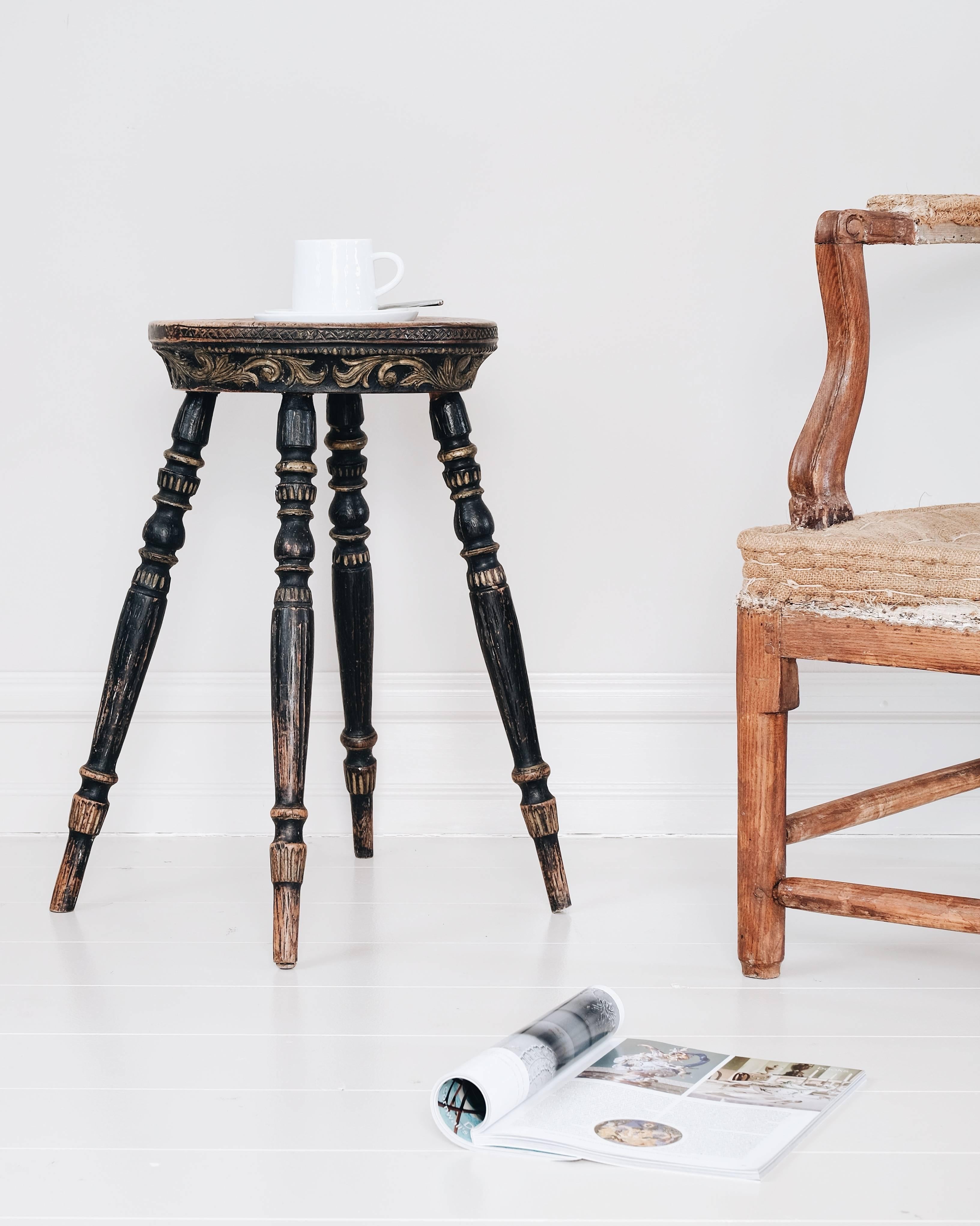 Delightful 18th century Swedish Folk Art stool with good transitional Rococo and Gustavian carvings, the secondary color most likely applied during the 19th century. Also works well as an occasional table or a sculpture stand.