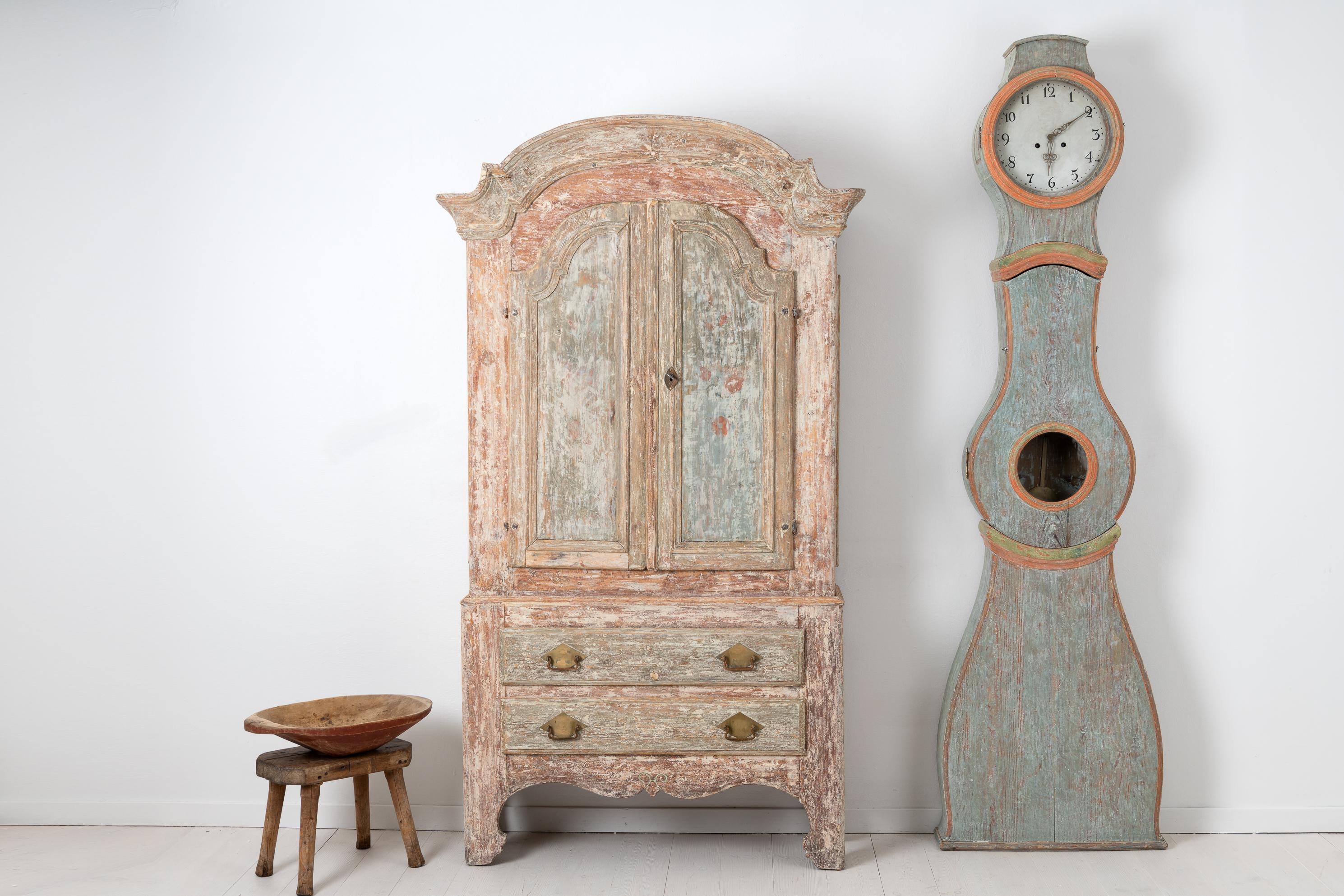 Swedish late 18th century rococo cabinet from the Swedish province Jämtland. The cabinet is a typical Swedish country furniture with clean design and skillful craftsmanship solidified in functionality and quality. Made in Swedish pine with traces of