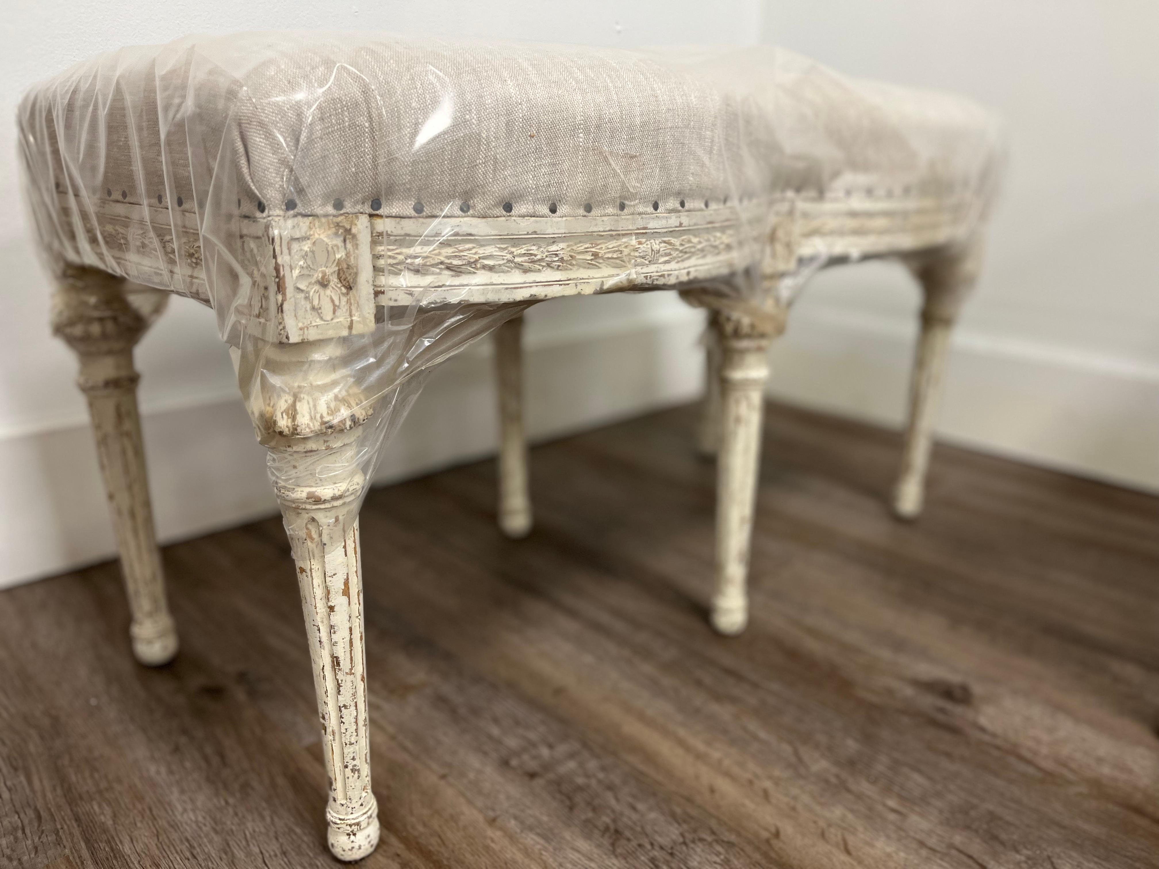 A unique hourglass shaped Swedish Gustavian bench made by Stockholm master furniture maker, Johan Lindgren (active 1770-1800). His initials, ILG, can be found underneath. Frame is decorated with horizontal leaf cut. Above each leg, front and/or side
