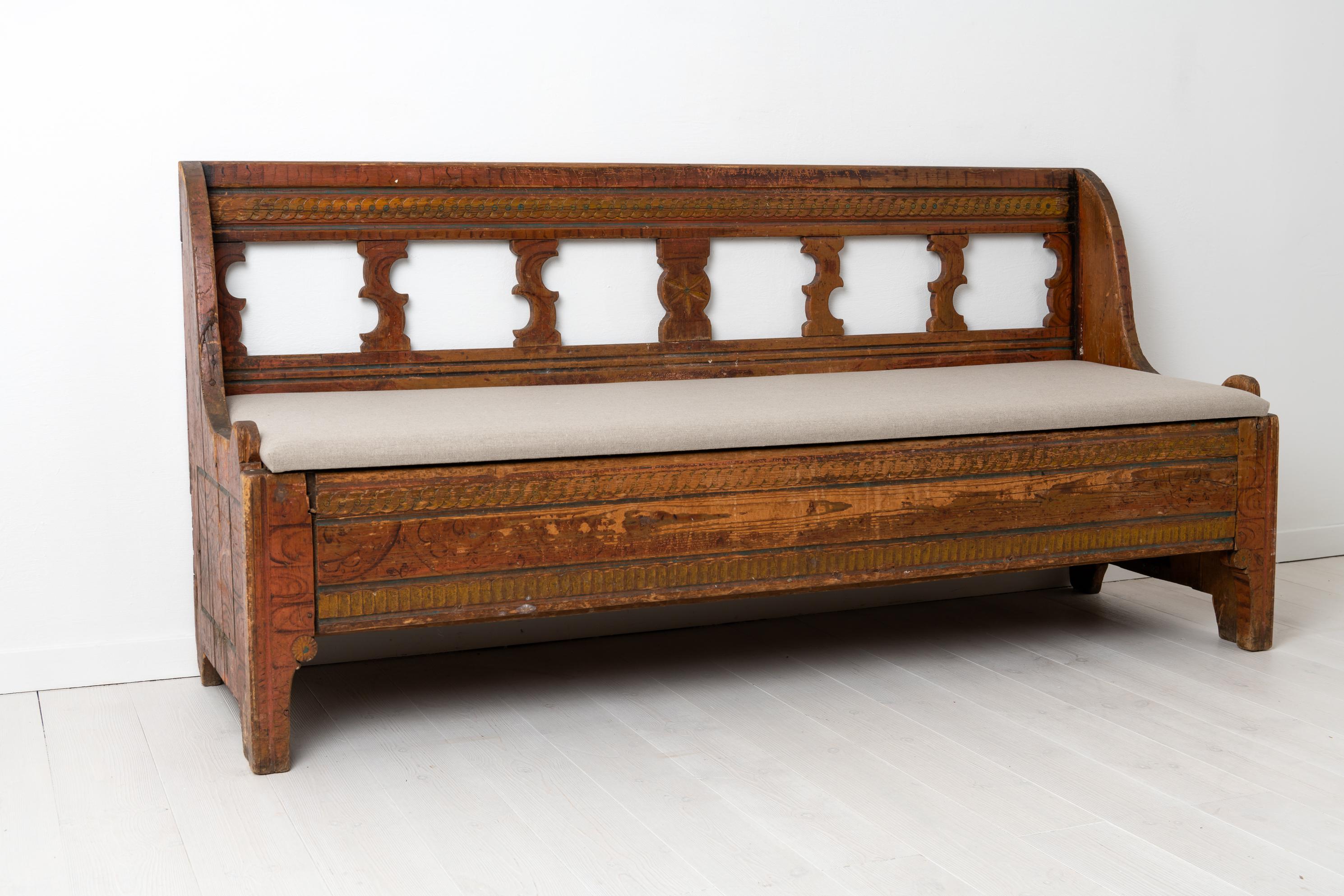 Gustavian country bench from the late 18th century. The bench is made in the very north of Sweden, close to the Finnish border in an area called Tornedalen. The bench is unusual and made in painted pine with the original faux paint and intricate