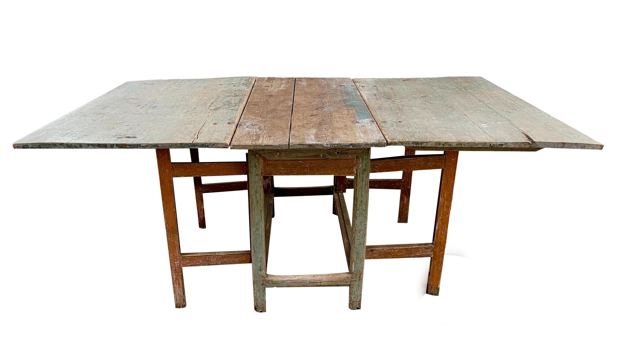 Exceptional 18th Century Swedish Gustavian Drop-leaf table, having original blue paint and wonderful original hand-wrought hardware.  30” h. 22.5 “wide when the table is folded down. The table has foldable table tops with double gates on both sides.