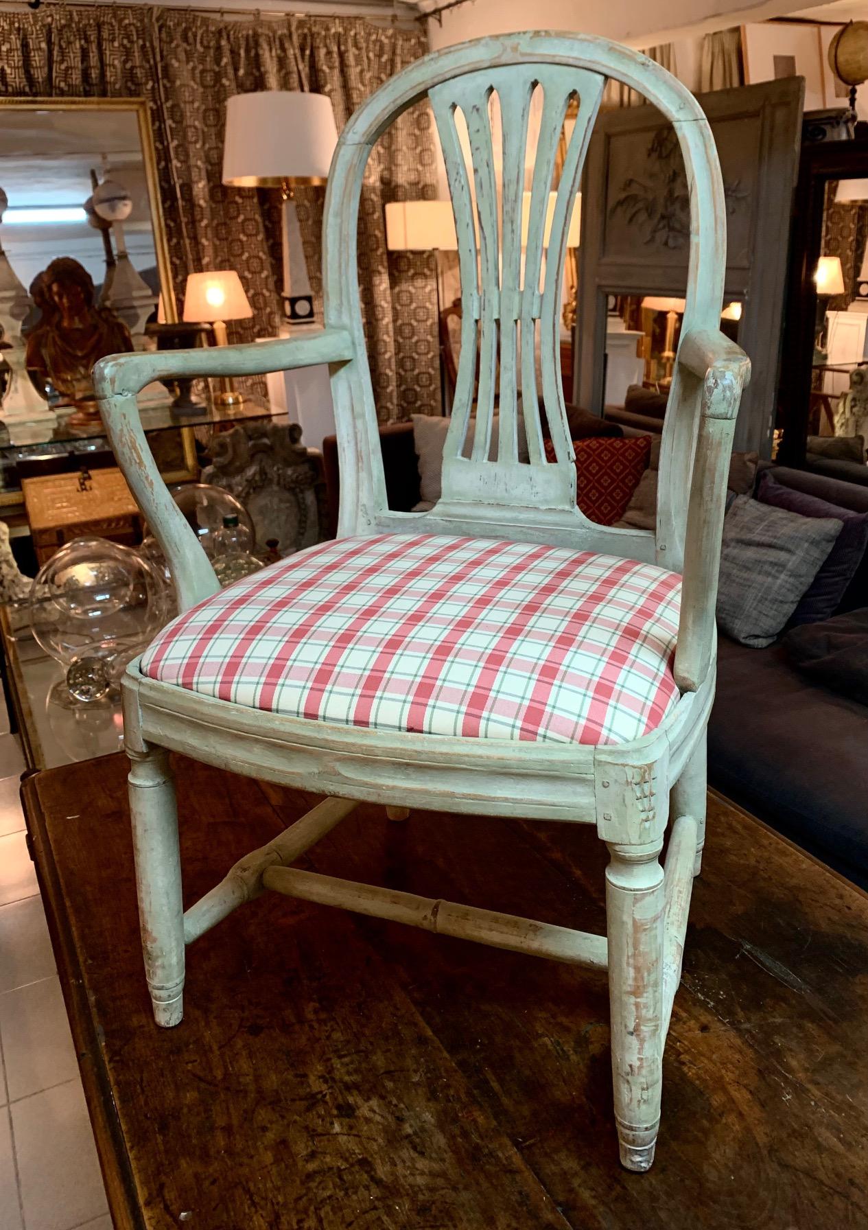 A pair of Gustavian period armchairs, hand carved and original paint in greenish gray finish, with nice and original patina, the seating is new fabric.