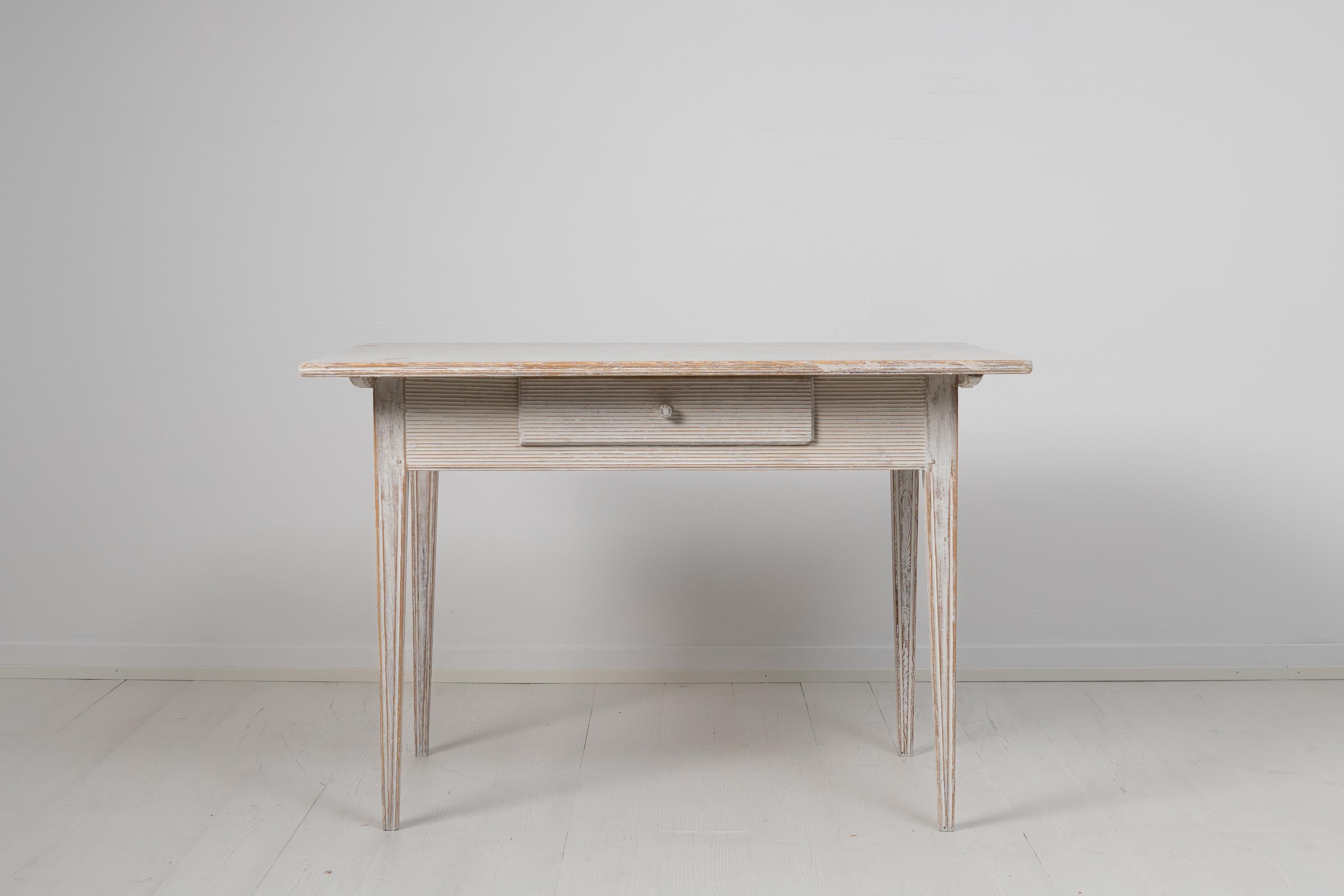 Northern Swedish gustavian table with a drawer hand-made in pine. The table is Neoclassic, or gustavian as the Swedish period is known as, with the classic gustavian decor. The table is from around 1790 to 1810 and has straight tapered legs with
