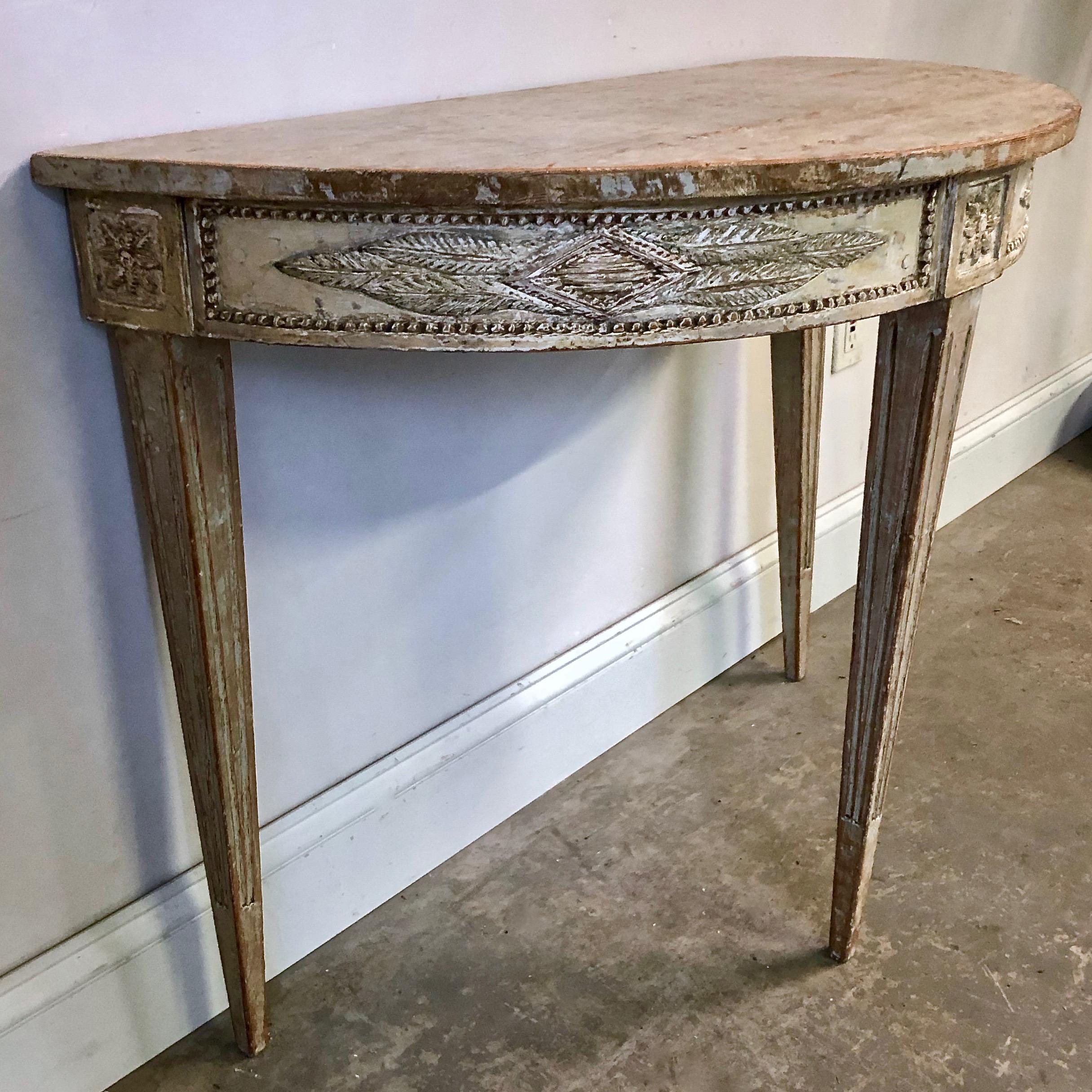 Very elegant 18th century Swedish period Gustavian freestanding console or table with richly decorated with diamond shape carvings on all around of the apron with florets at the corner blocks, wonderful tapered and fluted legs. This skillfully