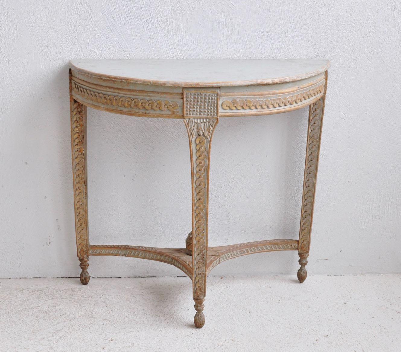 A rare and beautifully carved Swedish console table from the Gustavian period, hand-scraped to the original pale blue paint with traces of gilt detail, circa 1780. There is carved guilloché detail framing the apron and along the legs, connected by