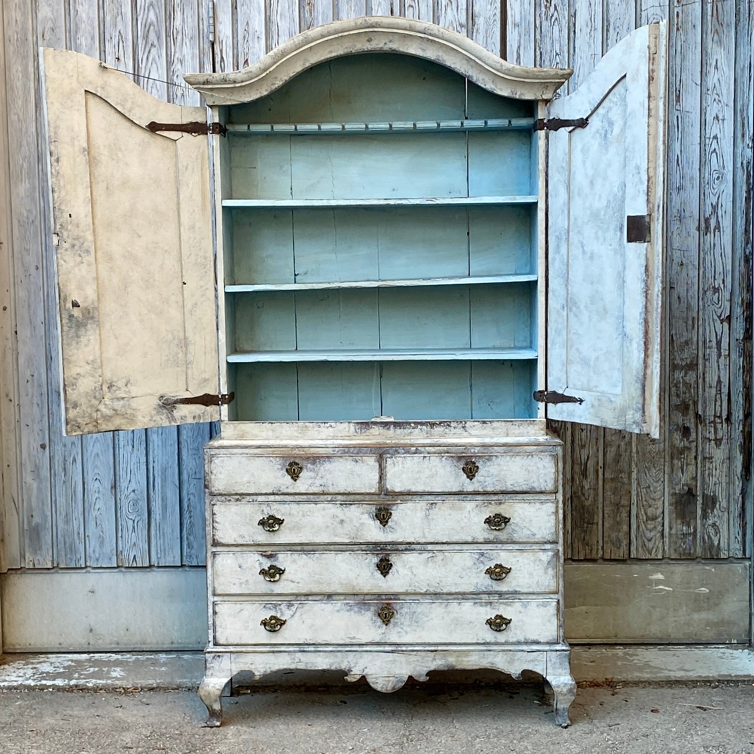 Two Part Gustavian Cabinet With Five Drawers and Two Top Cabinet Doors, Sweden circa 1770.

18th Century Cabinet in two pieces with wonderful arched cornice and original hardware. Upper unit features three shelves and one spoon rack in blue
