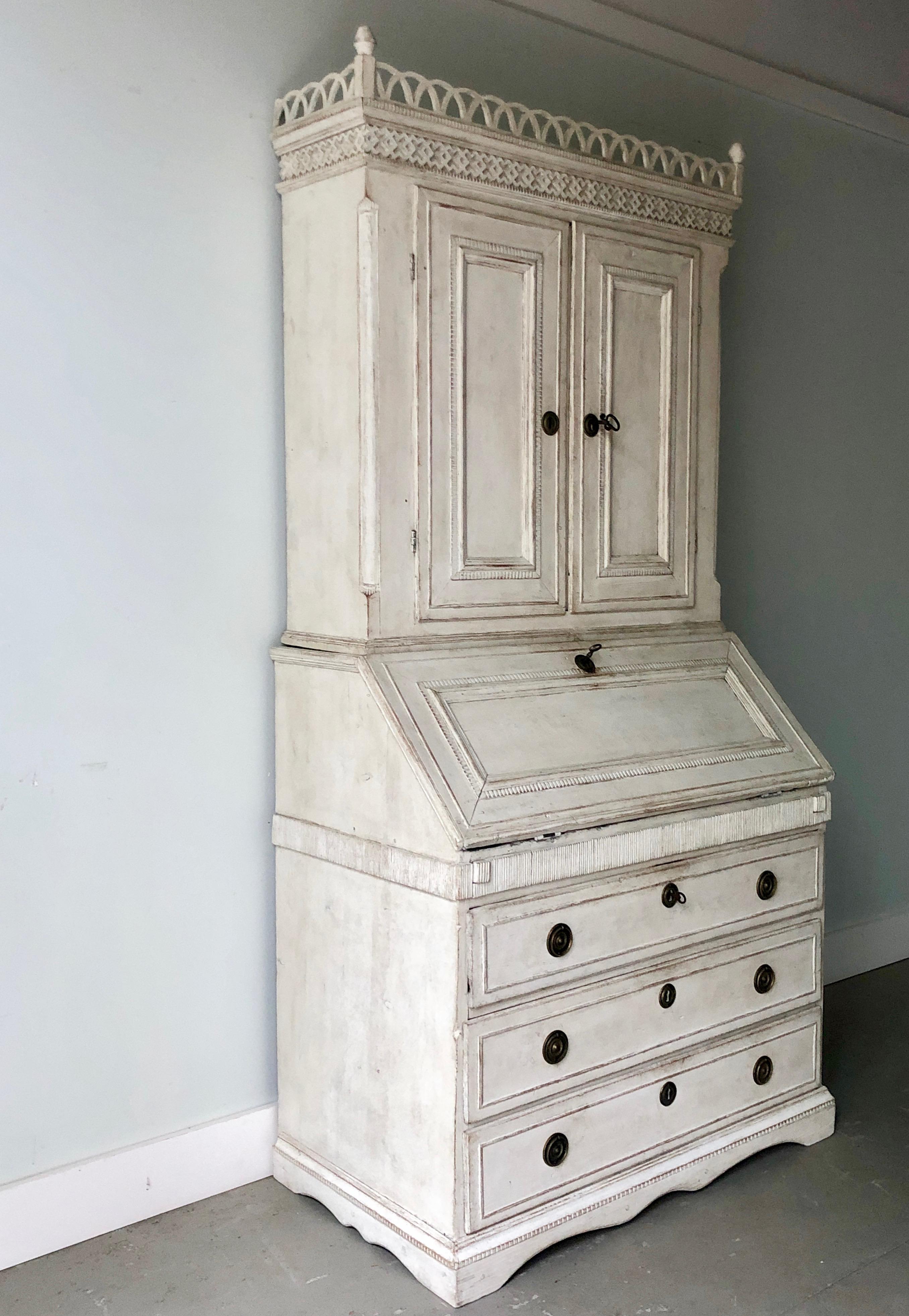 Very fine example of 18th century period Gustavian secretaire with richly carved balcony pediment cornice and fall front desk with multiple small compartments over a Classic three-drawer bureau on beautifully shaped skirt with feet, Sweden, circa