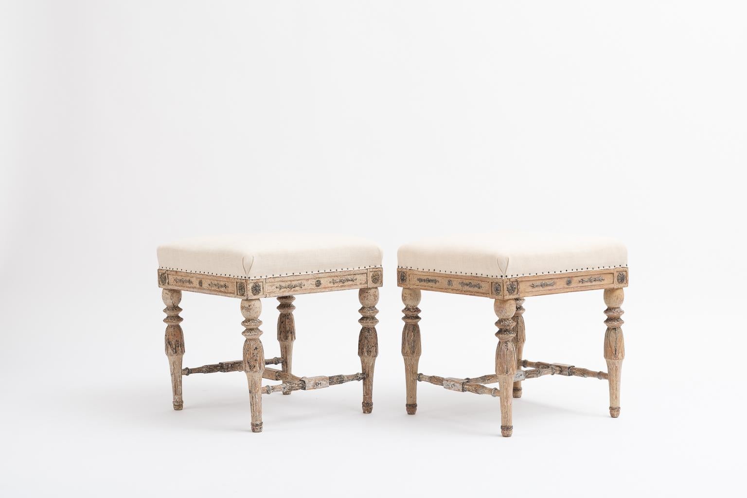 A pair of gustavian stools from the late 1700s, the end of the gustavian period. Dry scraped to original paint. They are well made and of good size making them functional and a charming addition to any room.

The seats are upholstered in handwoven