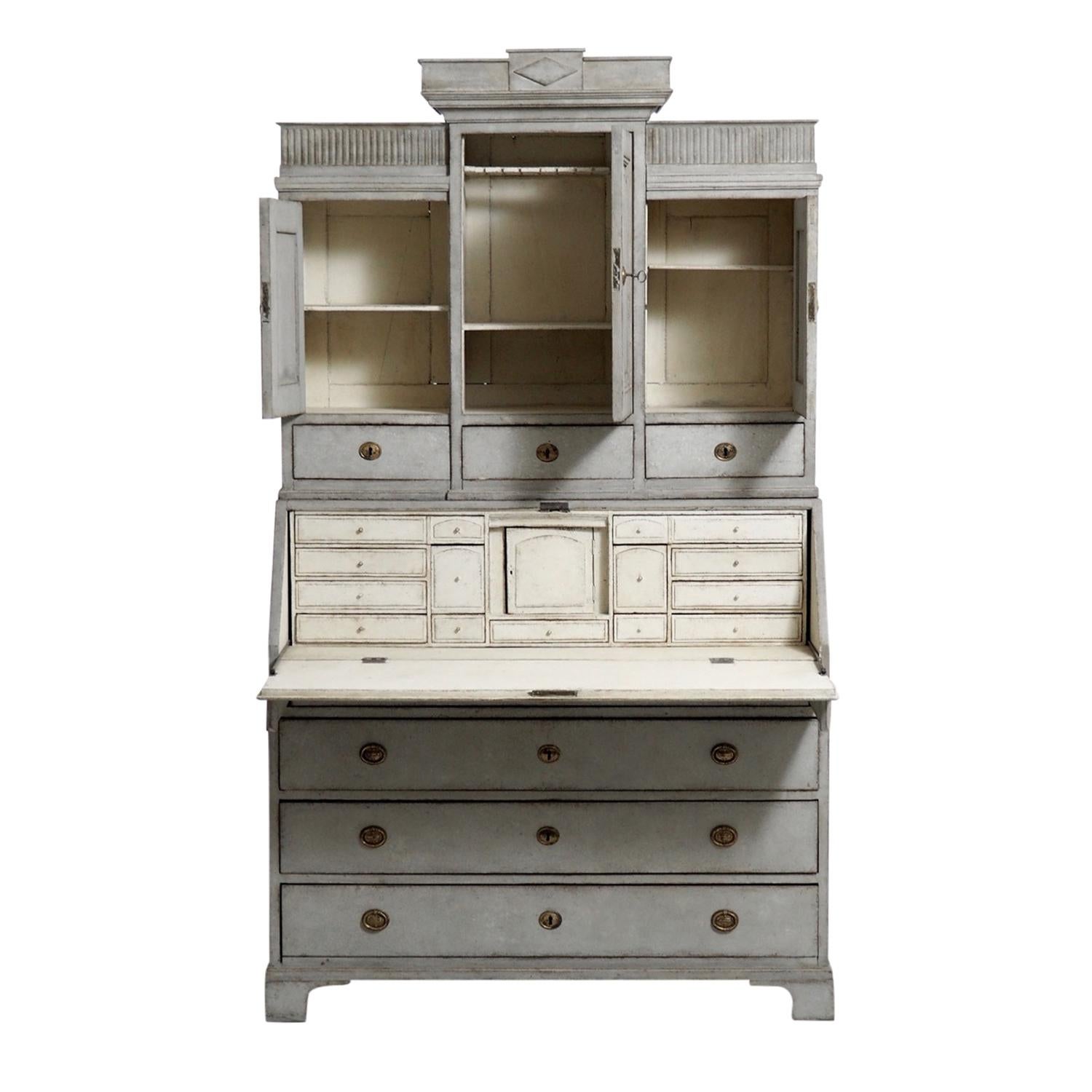 A 18th century, dark-grey antique Swedish Gustavian three part bureau, secretaire made of hand crafted painted Pinewood, in good condition. The arched upper section of the Scandinavian writing table is composed with three upper doors, three drawers