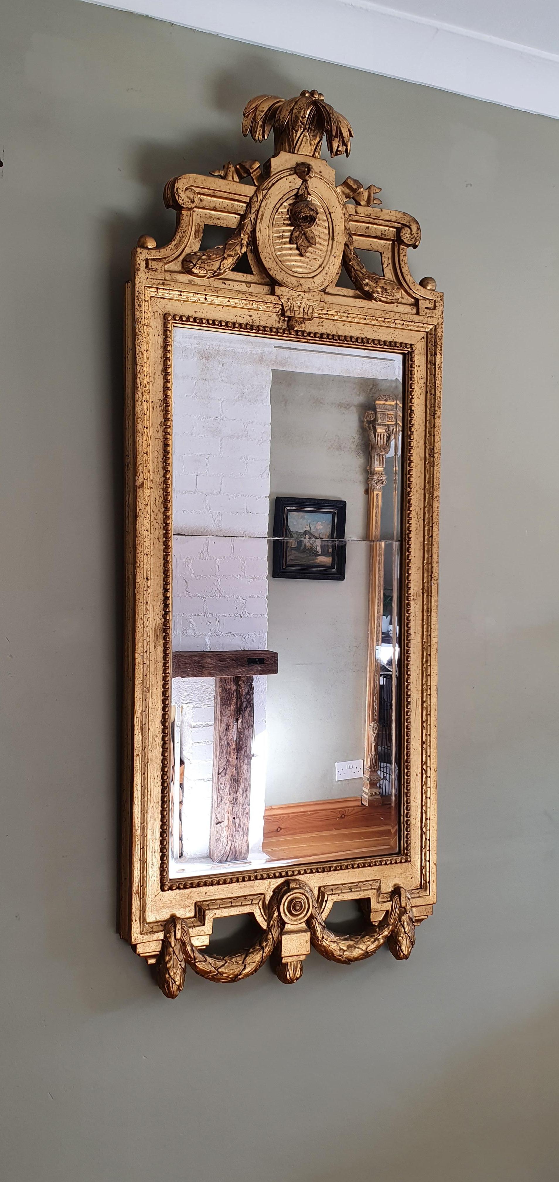 18th Century Swedish Gustavian giltwood mirror. Simple and elegant design, signed by master mirror maker Johan Akerblad . Original split mercury bevelled glass, later oil gilding. Date on the back 1781. 
Good condition with wear consistent with age