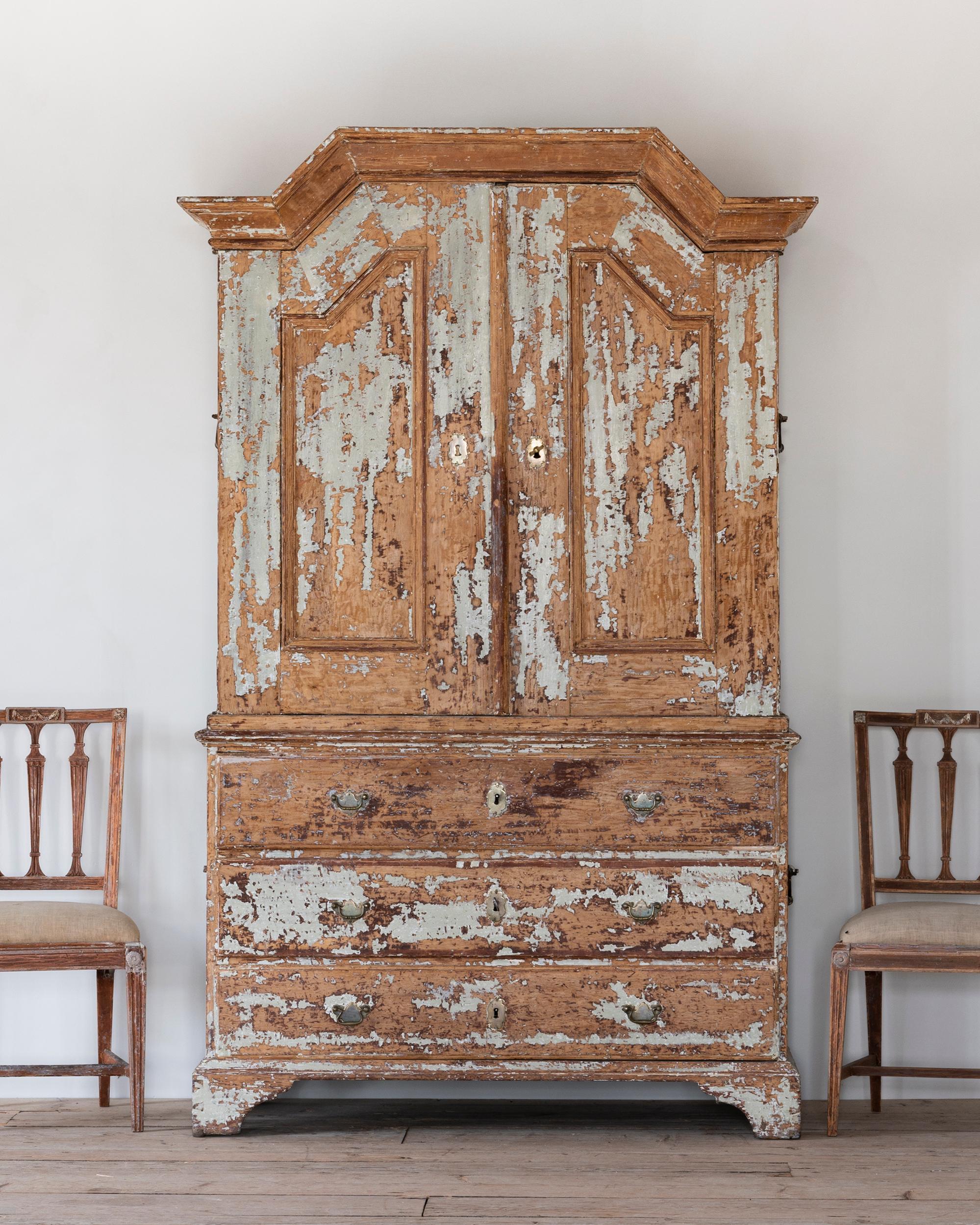 Fine 18th century Swedish late Baroque cabinet in Its original finish with traces of newer historical colours. Ca 1750 Sweden. 

Originally beige/yellow, then painted red and finally in a blue/gray colour that was popular in the early 19th century. 