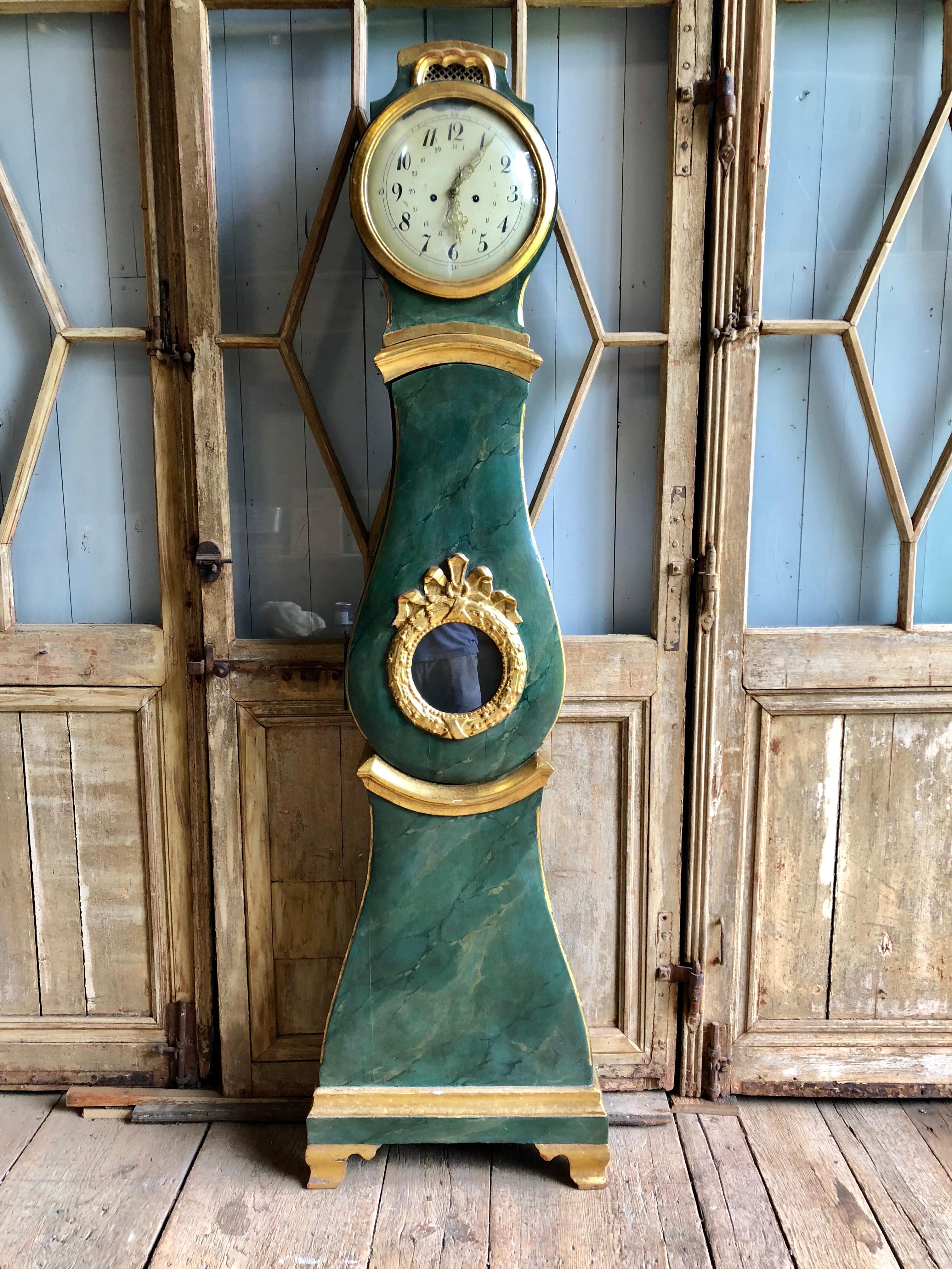 A fine 18th century Gustavian “Mora” tall-case clock from Sweden circa 1760, with painted dial and faux marble painted case with parcel gilt decoration.