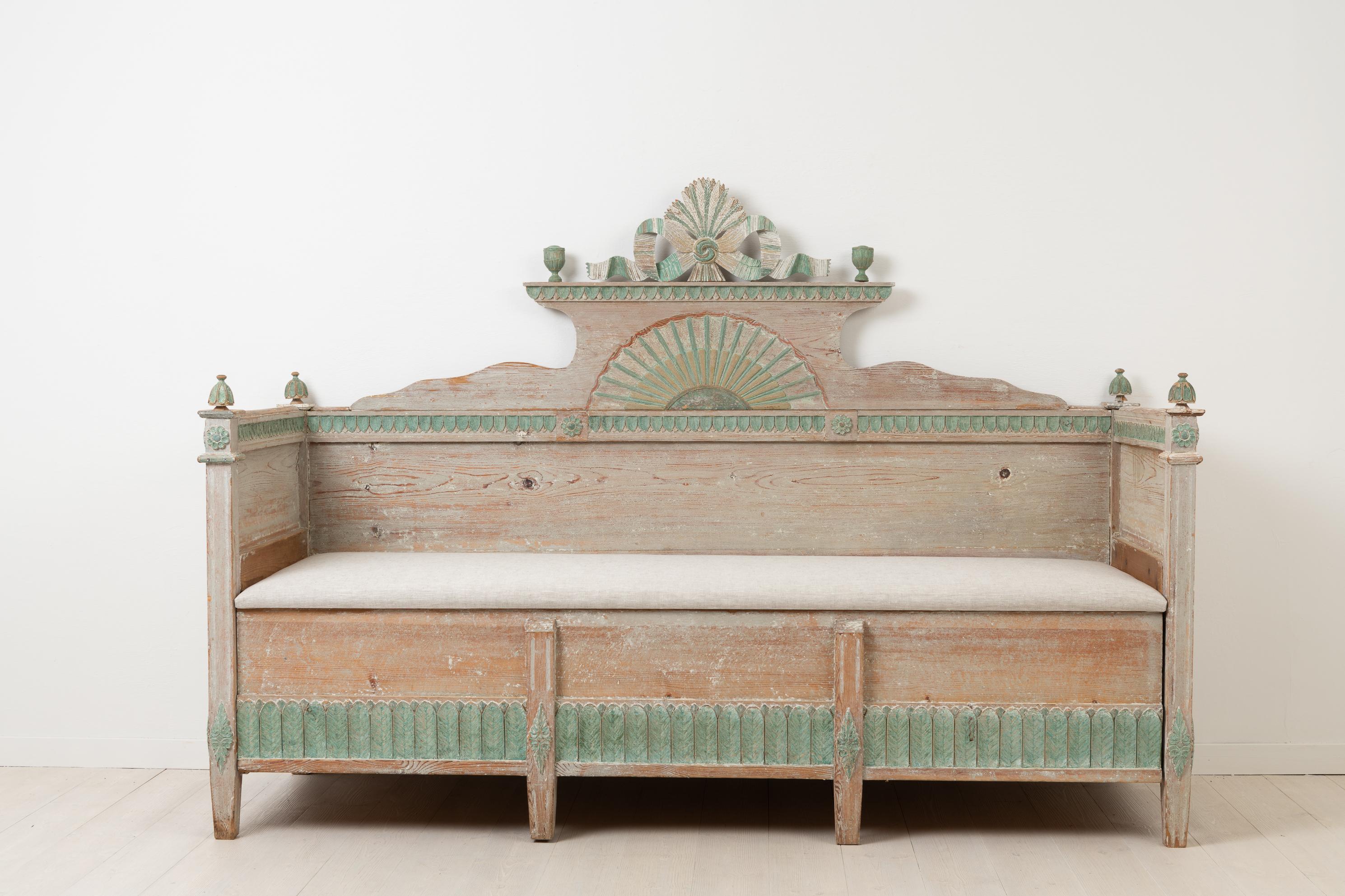Neoclassical / Gustavian Swedish sofa. Made in painted pine with unusually many and detailed decorations. Dry scraped by hand to the first original layer of paint. The wooden carvings are very strong and pronounced making them stand out even more in