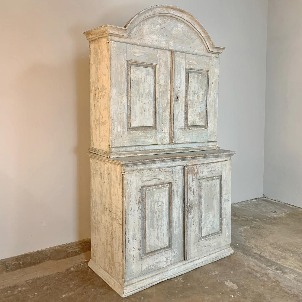 18th century Swedish painted buffet a Deux Corps will add a Gustavian flair to any room, an immediately command attention with its boldly arched crown and lovely patinated and distressed painted finish. Spacious interiors above and below only add to