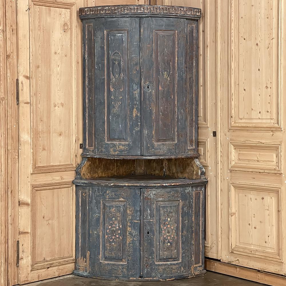 18th Century Swedish painted two-tiered corner cabinet represents the essence of tailored elegance, with a rustic charm that only the Swedes can produce! Encompassing a quarter of a circle, it features a smaller radius at the top section, with a