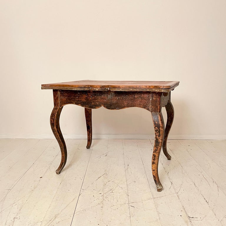 This beautiful and very rare 18th century Swedish European pine dining table is from the Baroque period. 
It remains its original condition and surface in Brown Red Color.
It is an Extendable Dining Table which is very unusual for this time and