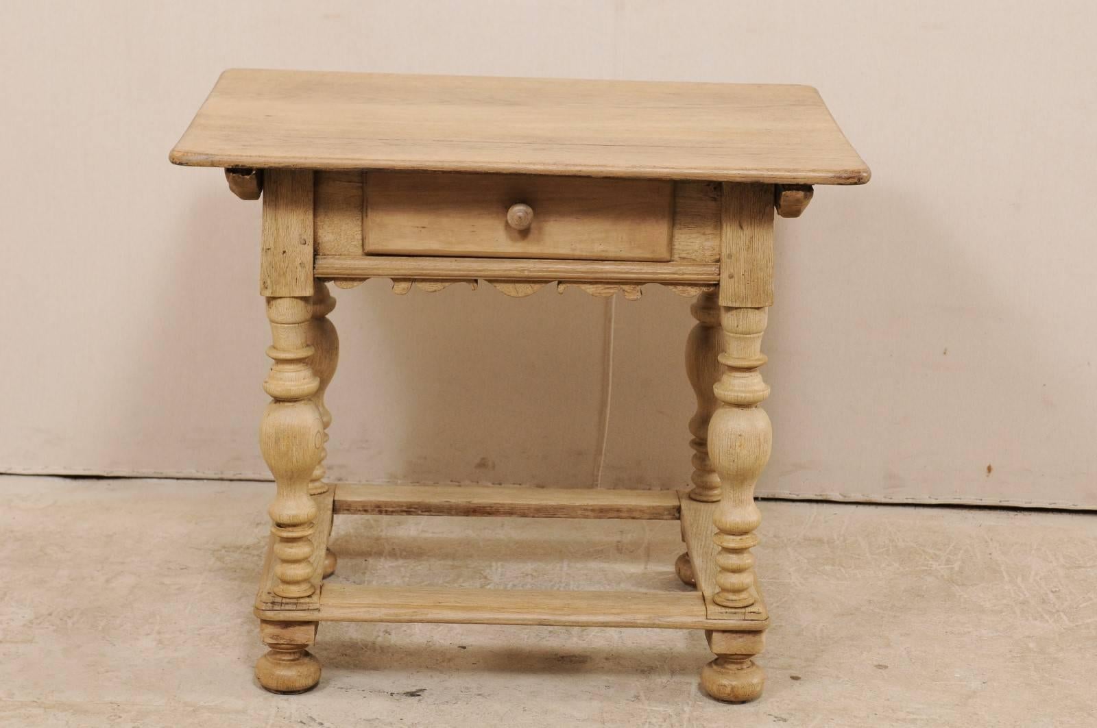 An 18th century Swedish period Baroque wooden side table. This antique Swedish occasional table features an overhanging top with single drawer below, and carved skirt along all sides. The four nicely turned legs, with box stretcher, each terminate