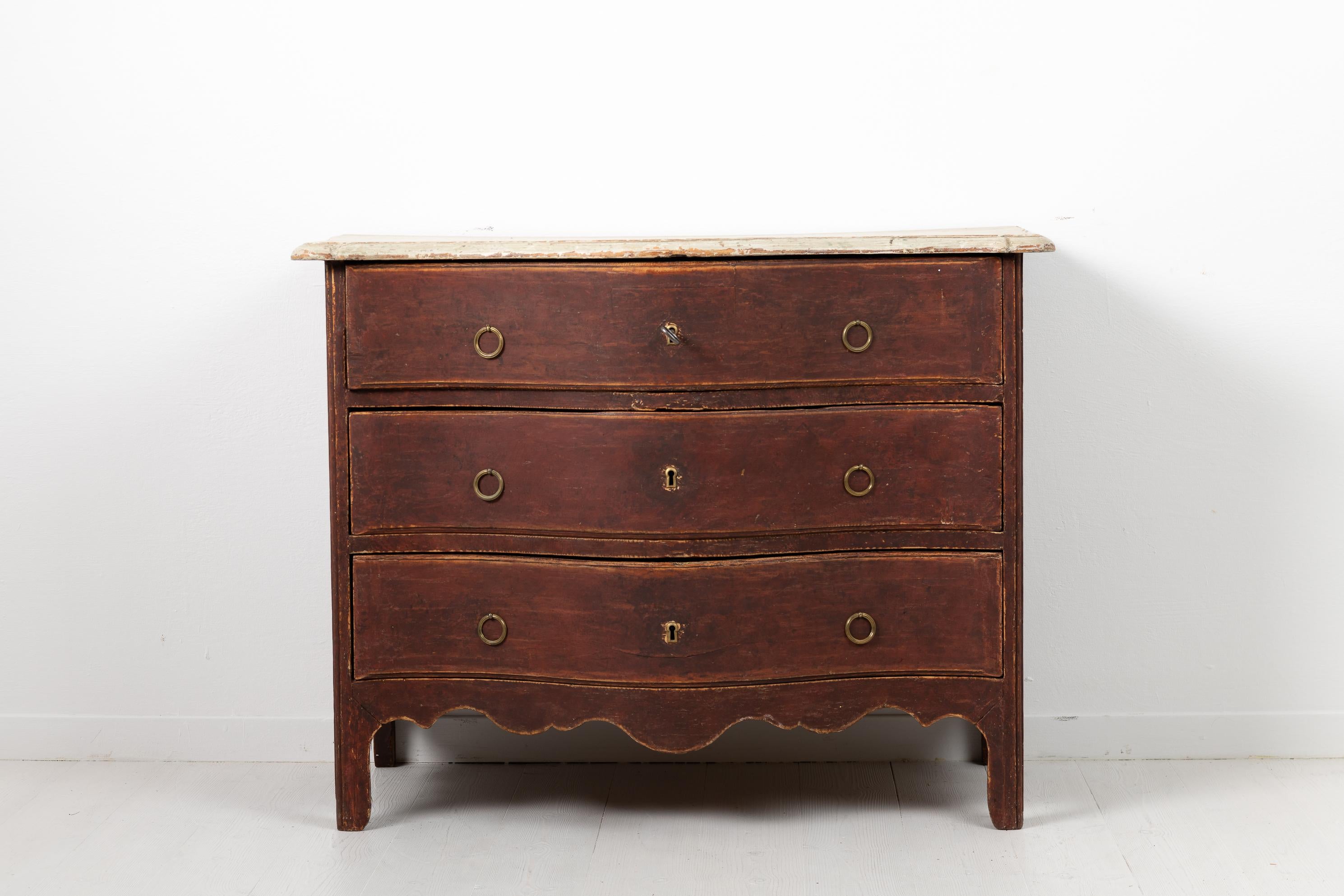 Baroque chest of drawers from Sweden made during the mid to late 1700s, around 1760 to 1770. The chest has old paint with distress and patina. The chest of drawers is an early example of great craftsmanship with a solid construction and great