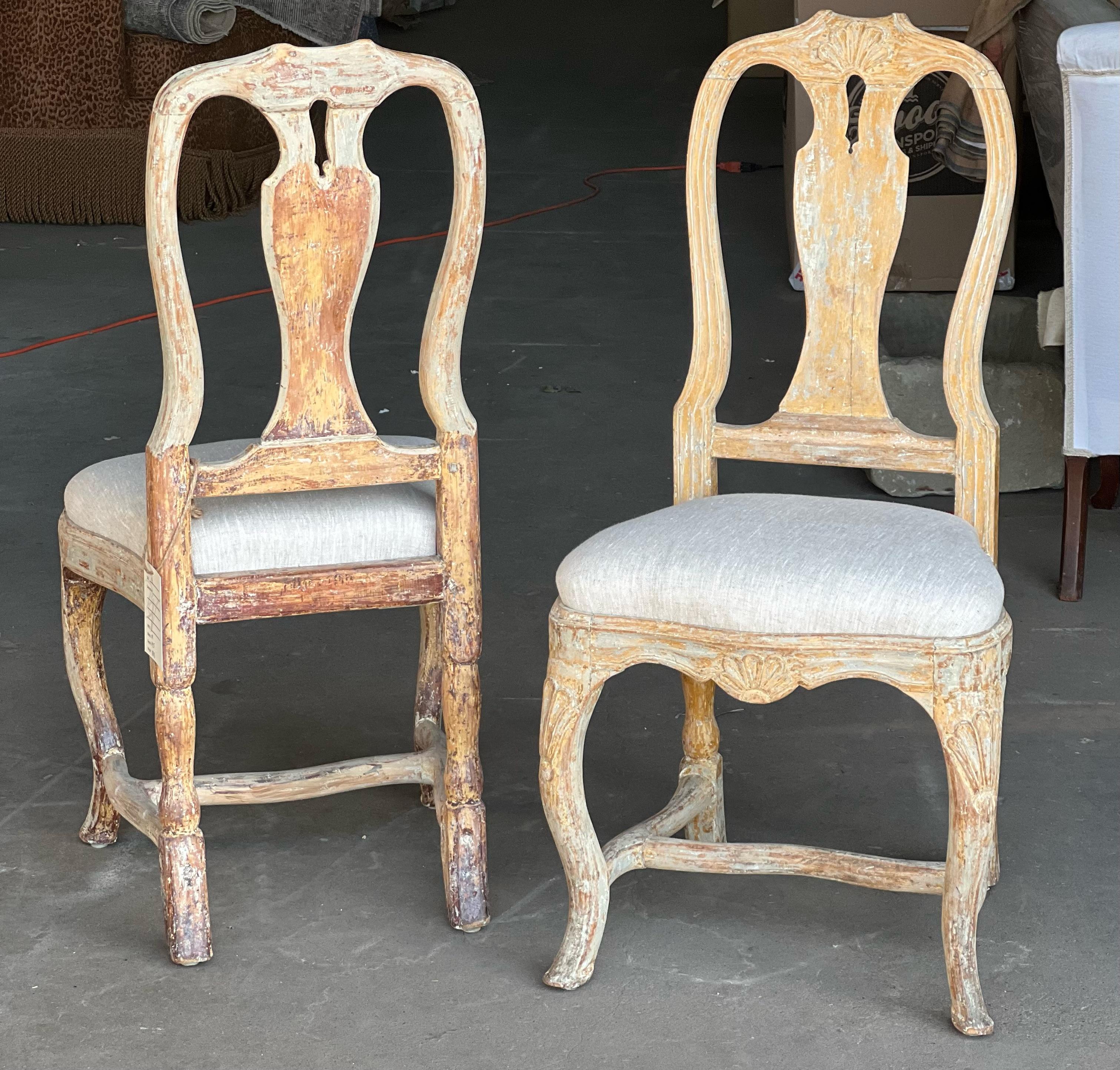 A stunning pair of Swedish Rococo chairs that are sturdy with nice proportions with hand carved details. This pair has been dry scraped to the original paint and has new linen upholstery. Mid to late 18th Century. Absolutely perfect for any design