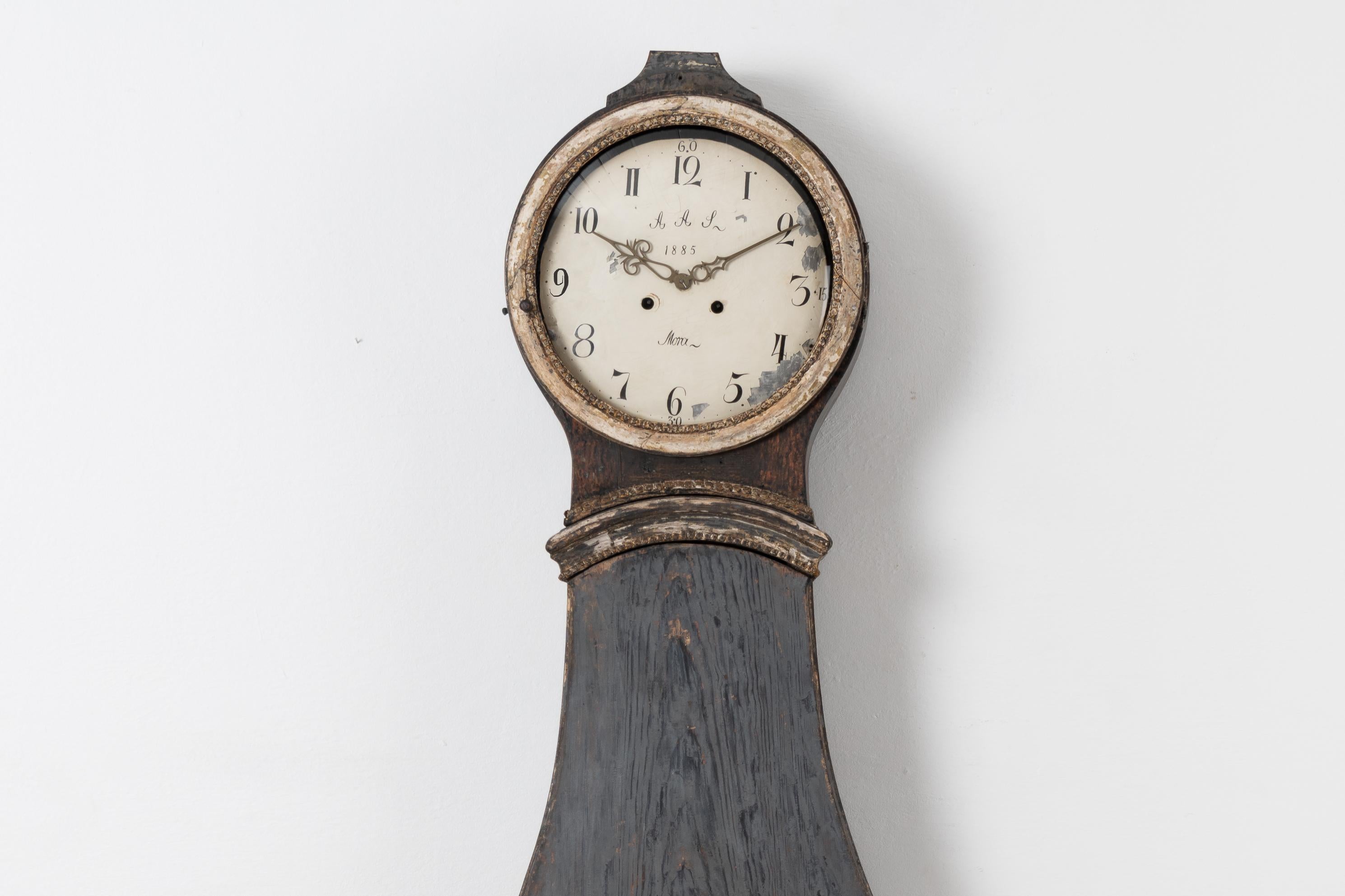 Rococo long case clock from the late 18th century with its origin in northern Sweden. The clock is pine with scarped to original paint. The end of the skirt has a very nice typical rococo shape and transition to the feet. Hand carved wooden decor