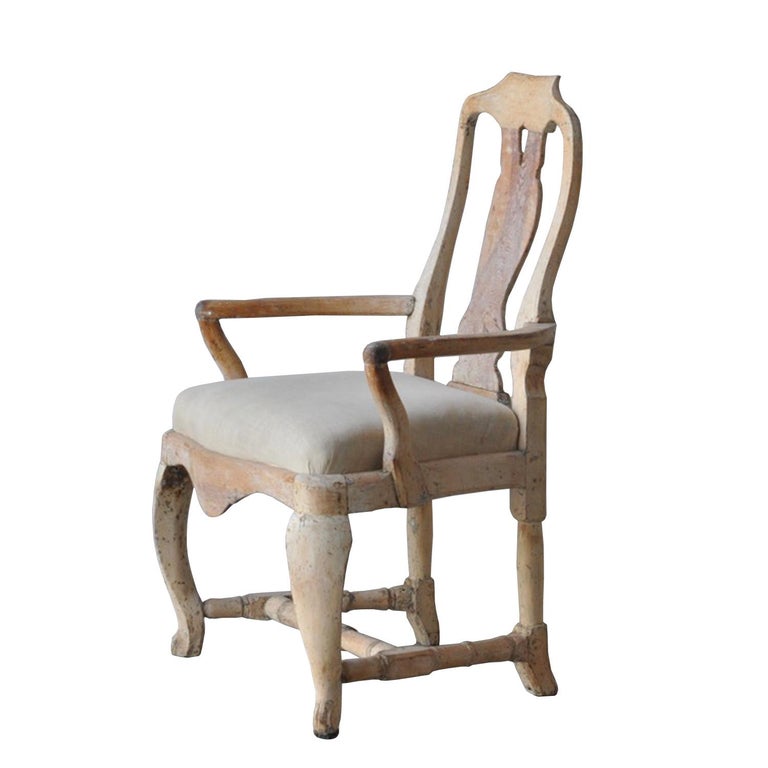 A provincial period armchair scraped to original paint. This piece has been reupholstered in linen.
