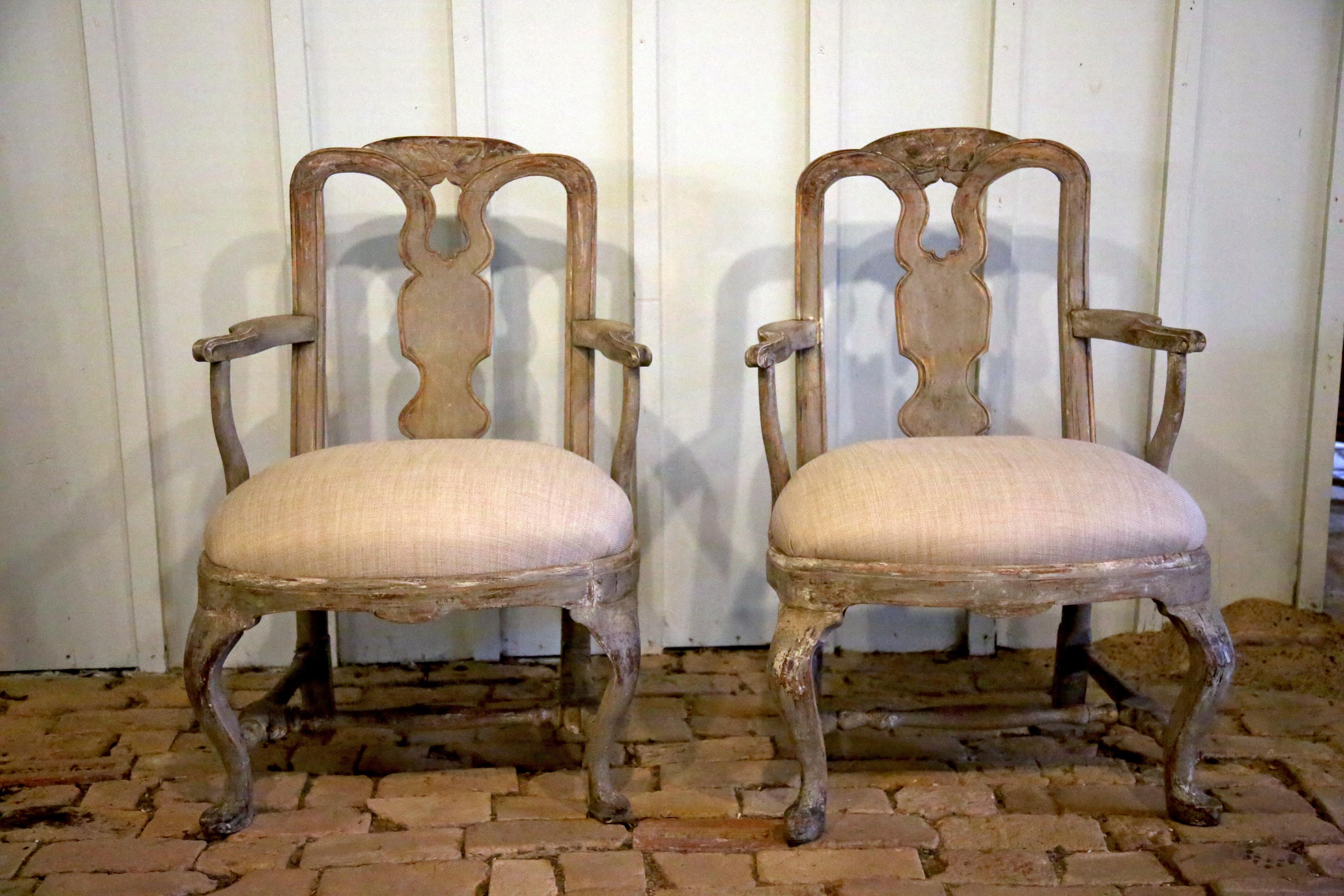 18th Century Swedish Rococo pair of armchairs that have been dry scrapped to the original paint with the natural wood showing through and features new upholstery. The patina is a fabulous color with this one and allows this pair to become a piece of