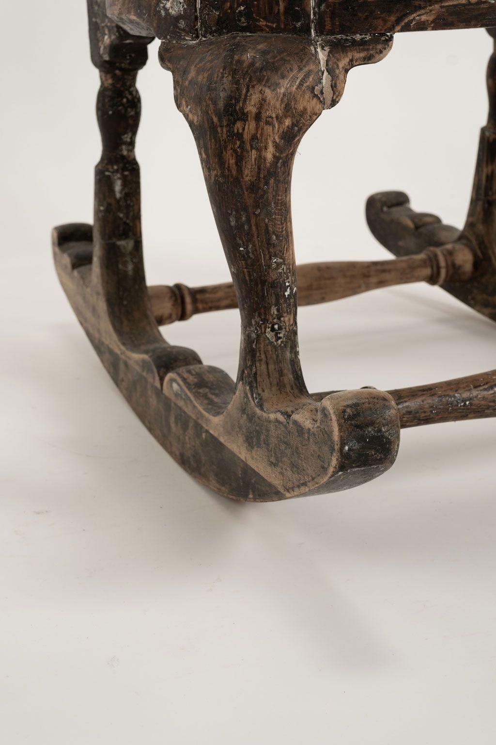Chaise à bascule suédoise rococo du 18e siècle, vers 1730-1769. Magnifique chaise à bascule de Suède. Décoration et pieds cabriole sculptés à la main dans le style et la période rococo suédois. L'entretoise est tournée et le dossier est formé d'une