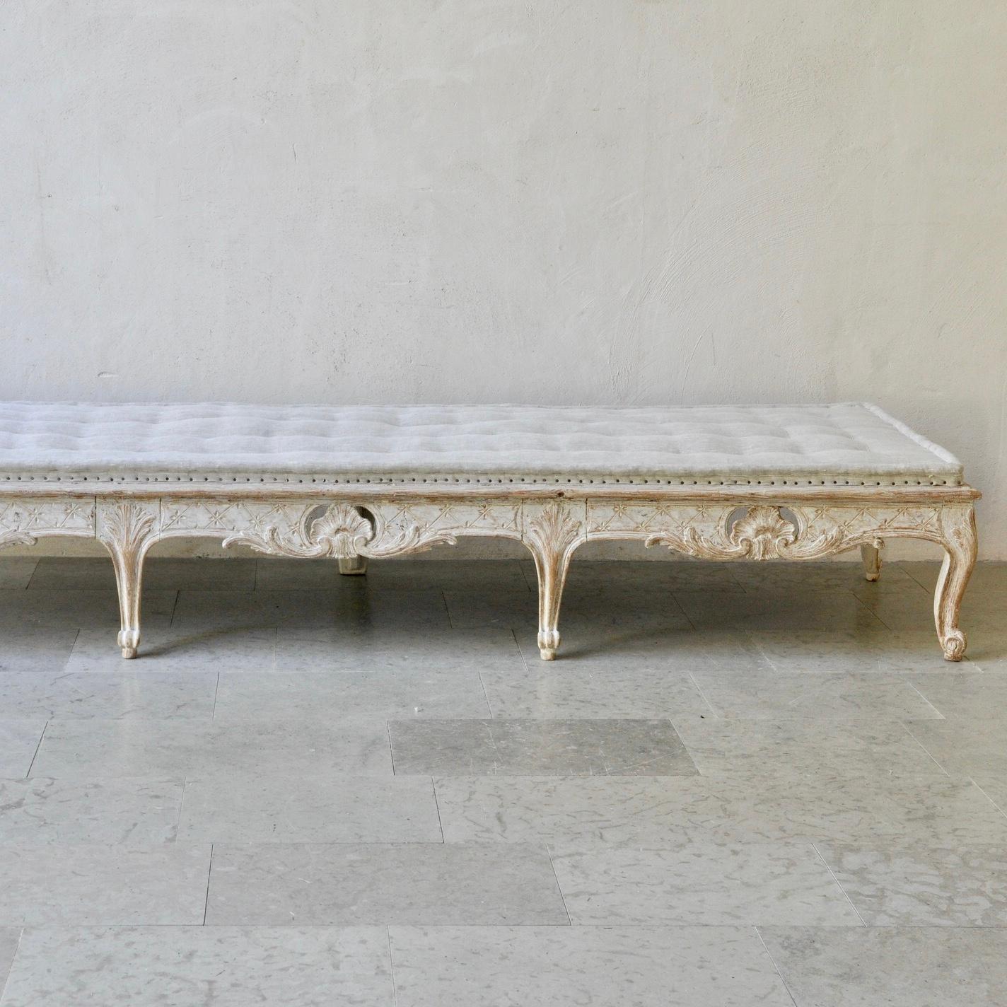 Large 18th century Swedish period Rococo long stool/bench - classical Rococo hand carved shell decoration to front and both ends (plain to the back) - traditional tufted Swedish upholstery in a neutral linen - original old paint has been refreshed