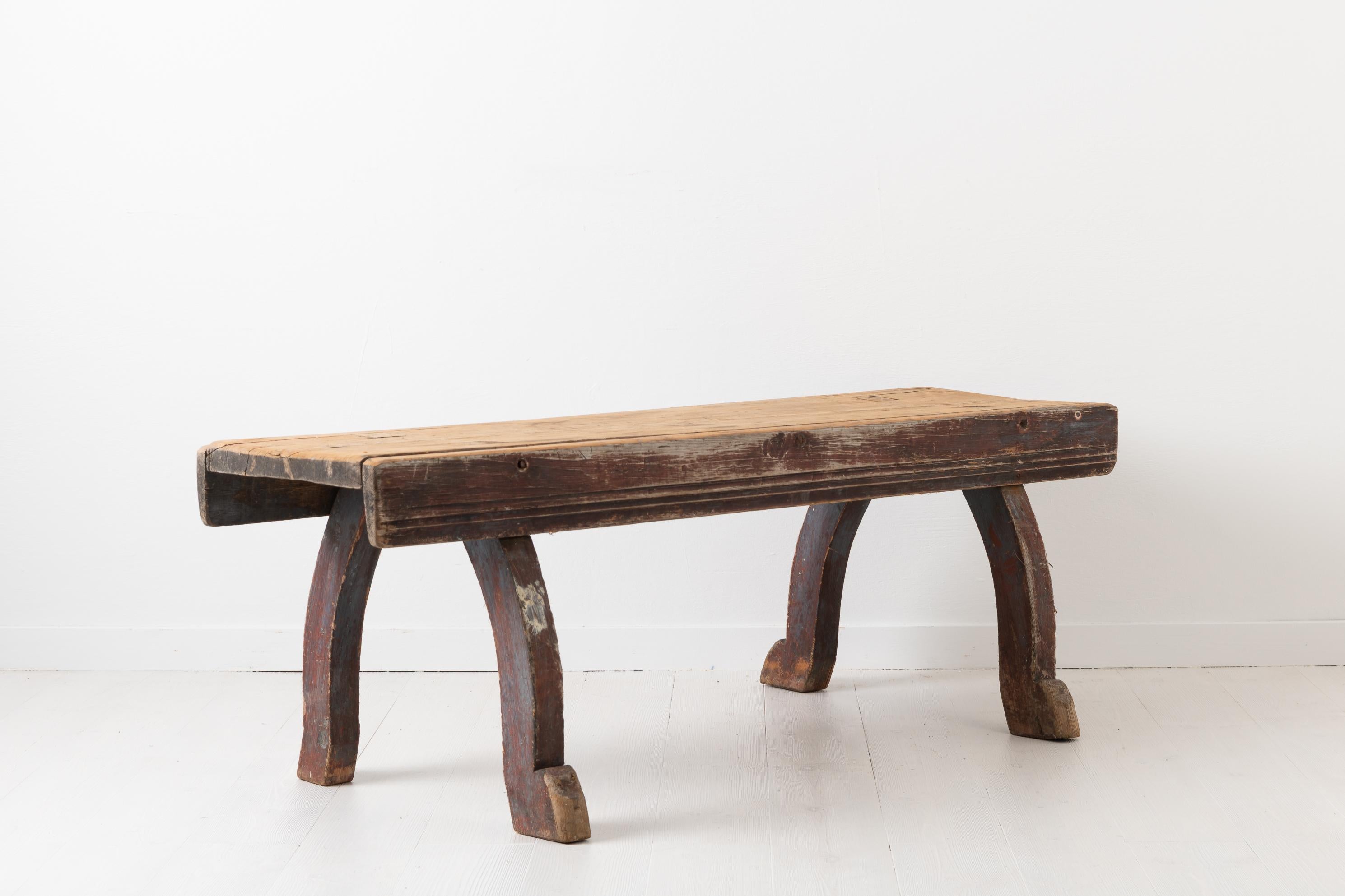 Northern Swedish Folk Art bench from the late 1700s. The bench is Primitive and rustic and has a lot of character, especially given the original distressed paint and authentic patina. The legs are curved in Rococo style and the edges of the seat