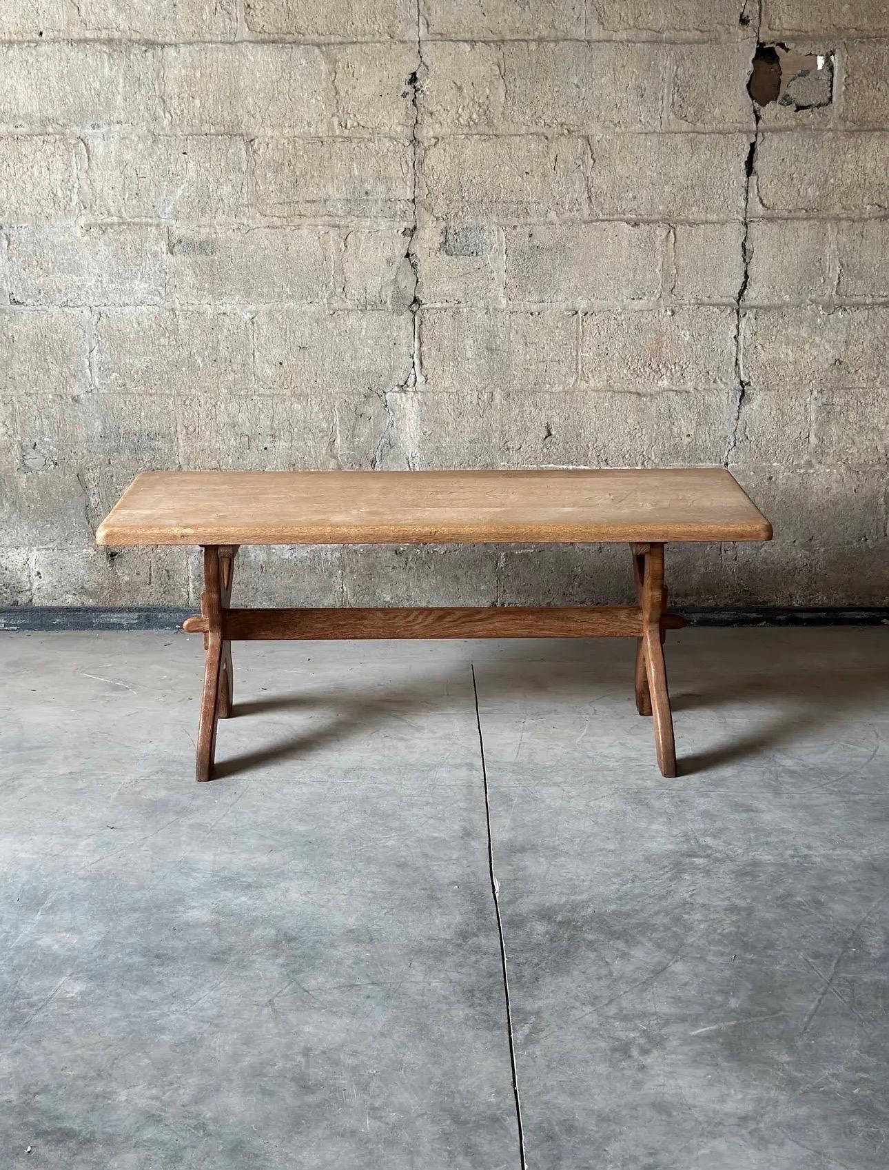 Evoke warmth with this antique Swedish country sawbuck coffee table in a natural finish. Dating from the late 18th century, it’s carved from fruitwood with a rectangular top and X-form base. 