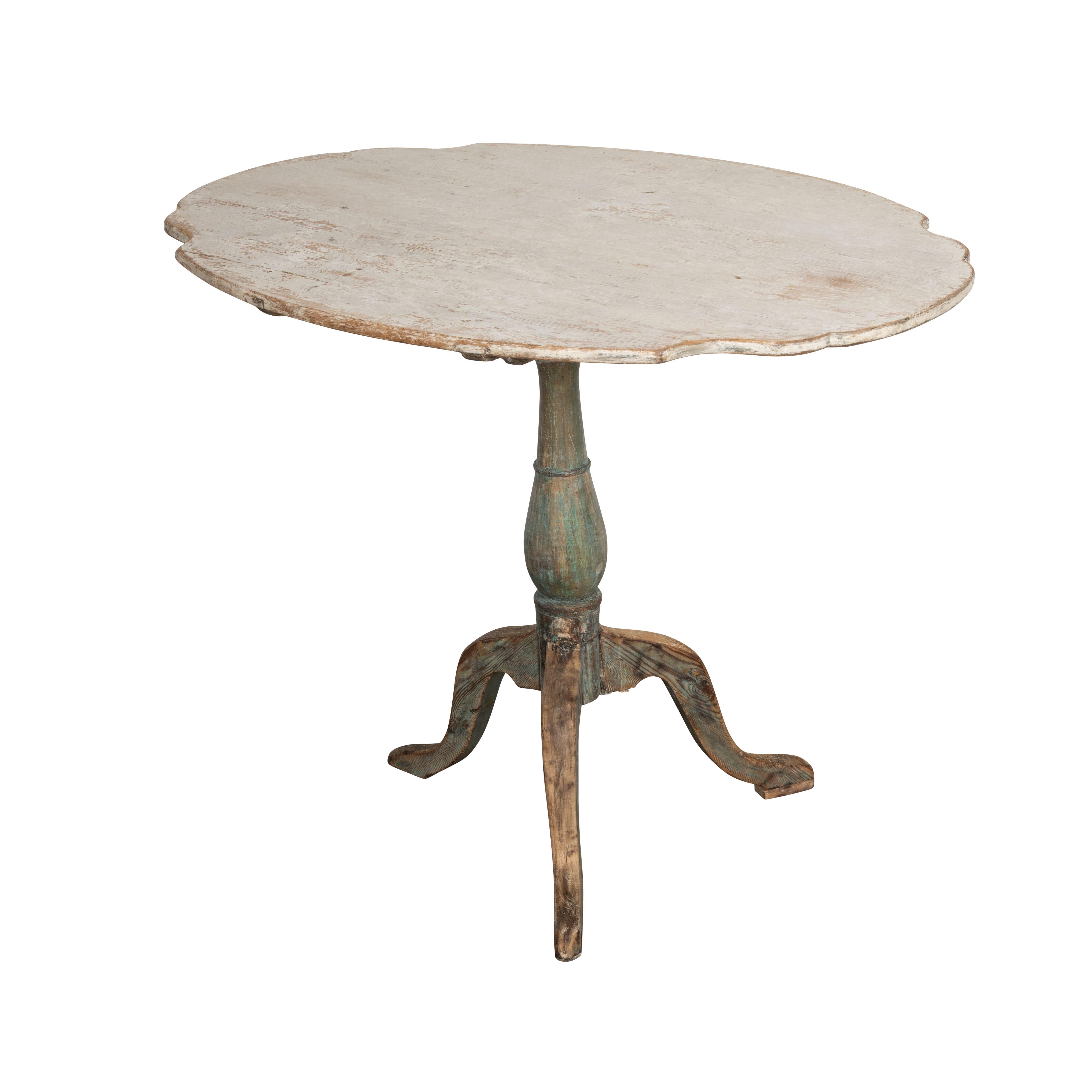 18th Century Swedish tilt top table.
With a decorative shaped top below a tripod base. Dry scraped back to original paint.