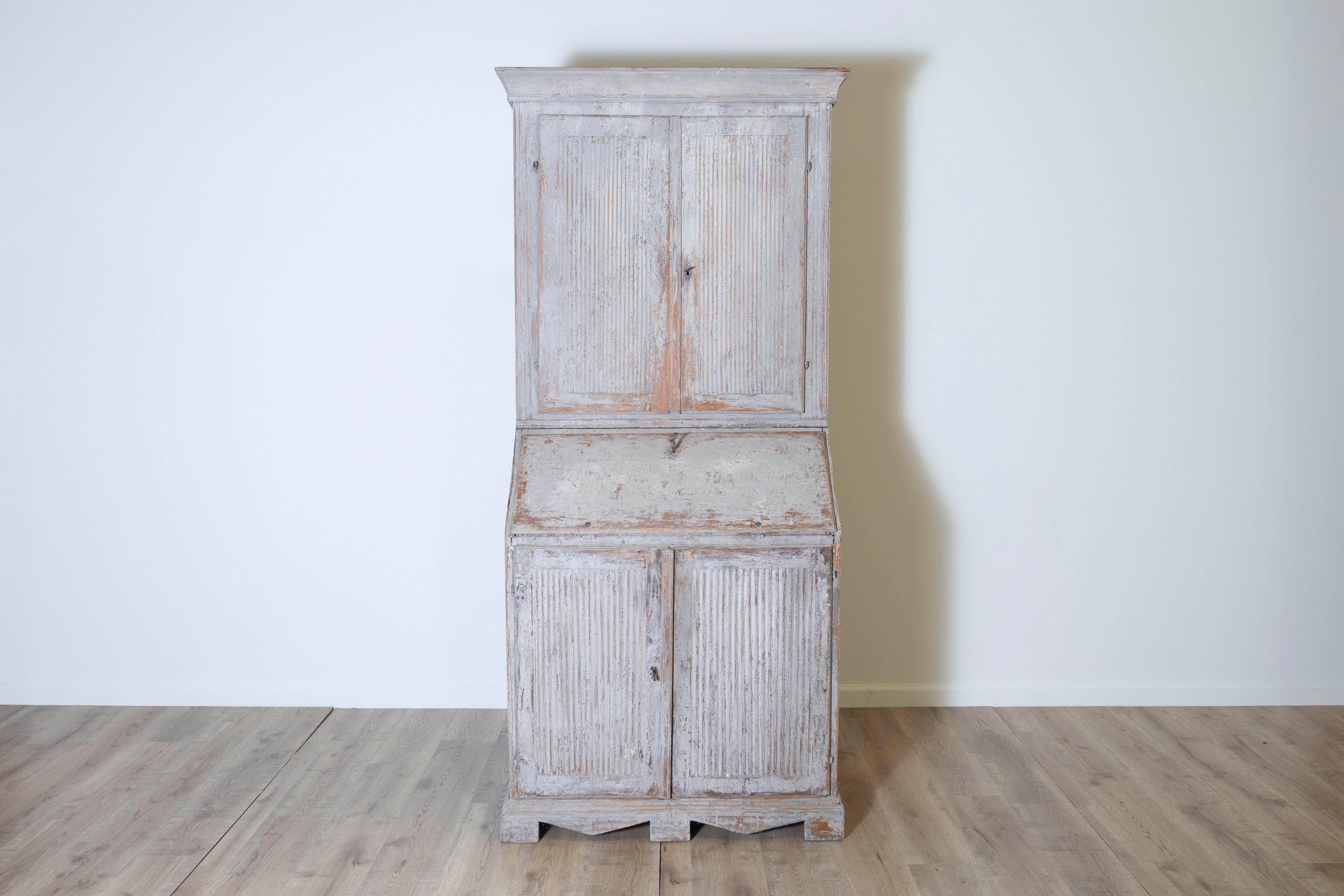This Gustavian writing cupboard is an exceptional example of late 18th-century Swedish craftsmanship, blending elegance and practicality in a timeless design. It features unusually well-carved sides, adding a distinctive decorative element to its