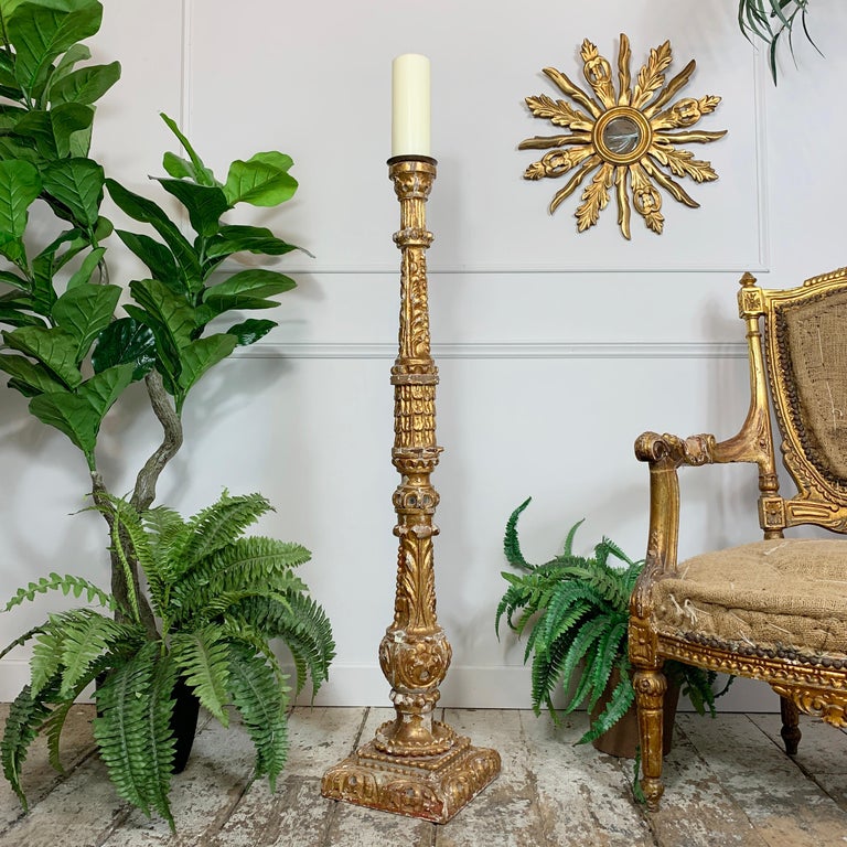 A remarkable 18th century German Baroque church altar candlestick, carved wood and gilded gesso, dating to circa 1760, this very large scale pricket candle stick is profusely decorated and includes mirrored detailing throughout. There are obvious
