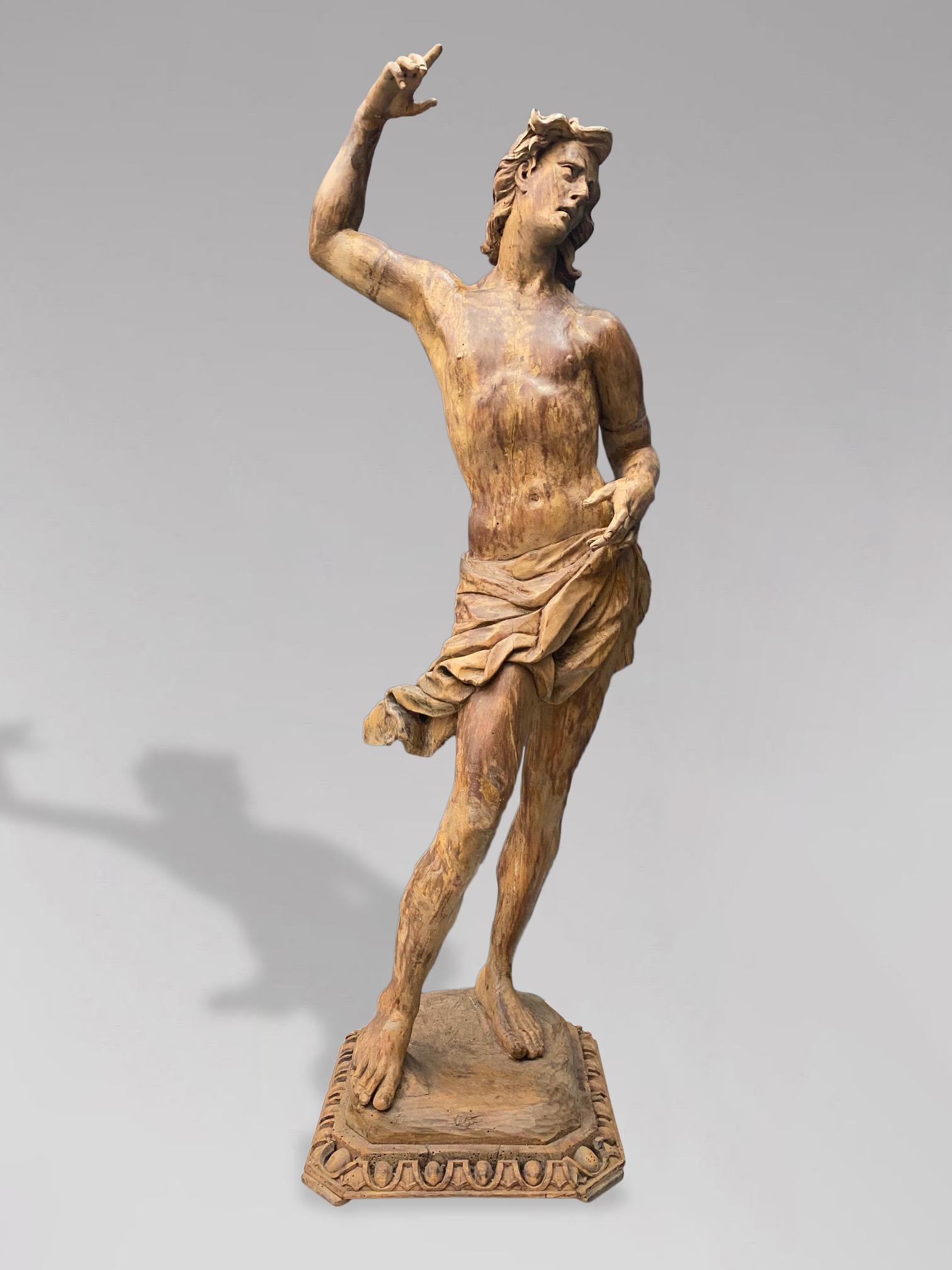 A stunning tall 18th century male life like antique sculpture of St. John the Baptist, carved from wood and once a decoration from a French church or cathedral. This statue will add depth and meaning to any contemporary home. This statue will work