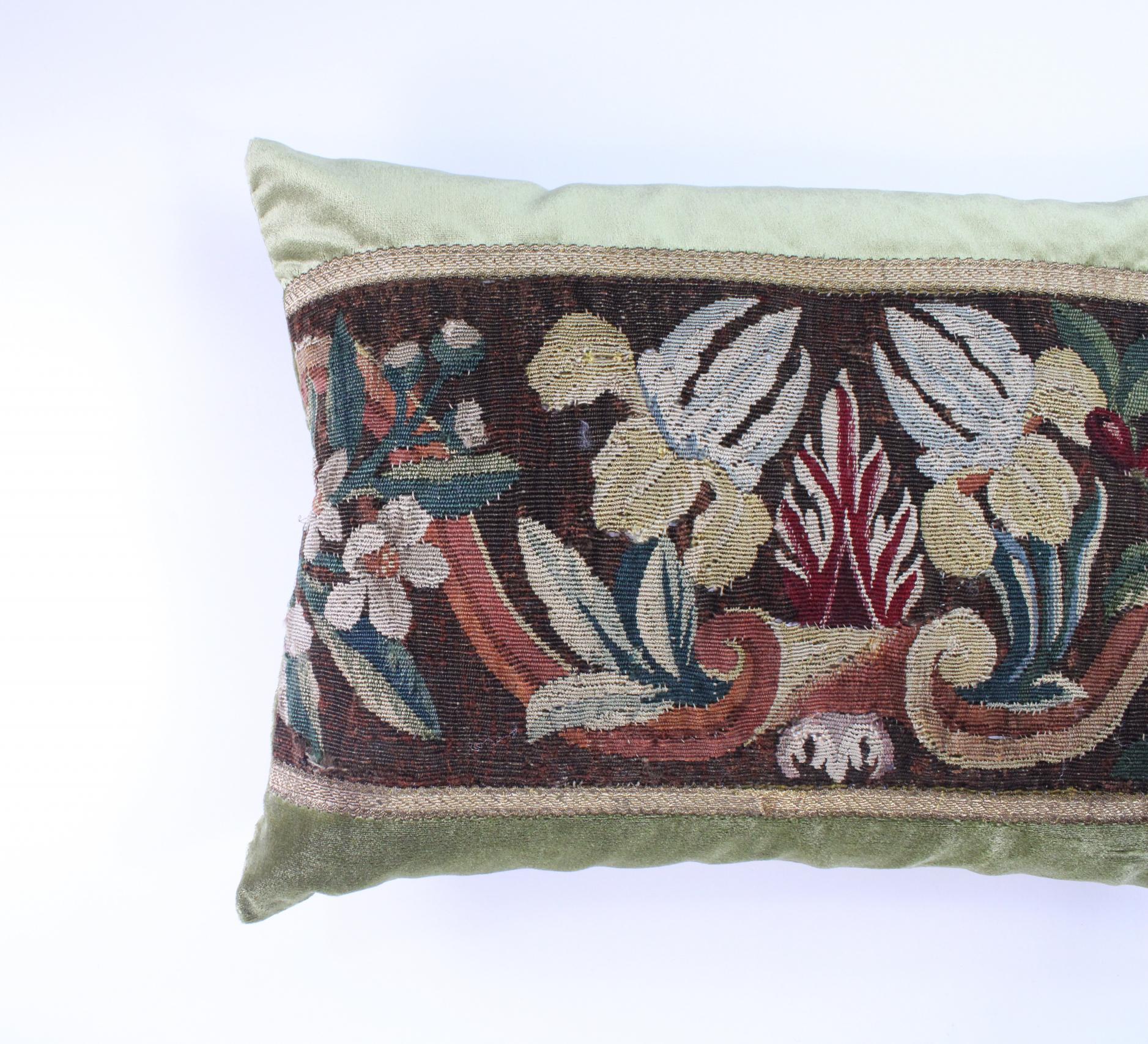 Wear consistent with age and use. This is a new pillow using an antique tapestry piece framed with French gold gallon and gorgeous Schumacher silk velvet. Down filled.