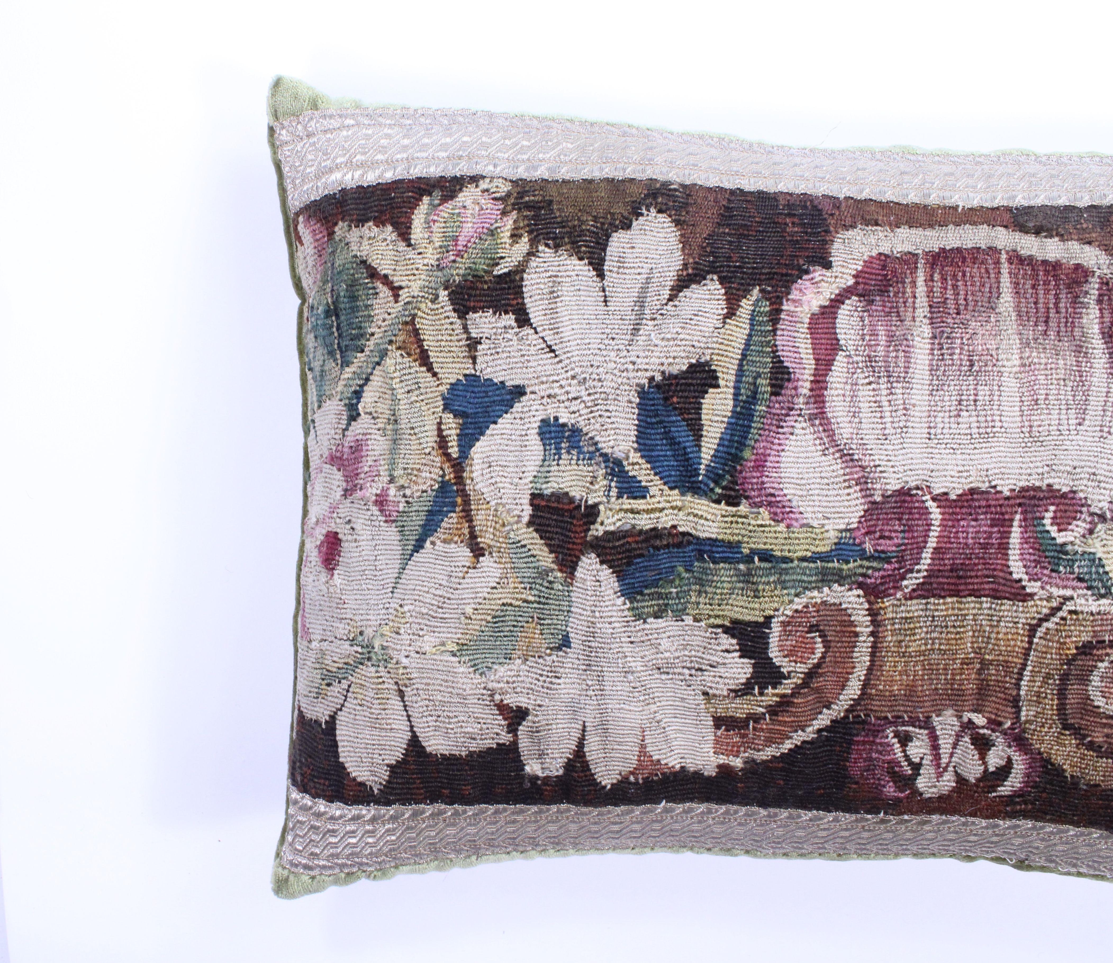 This is a new custom pillow with an antique piece of tapestry framed with antique French gold ribbon and gorgeous Schumacher velvet.