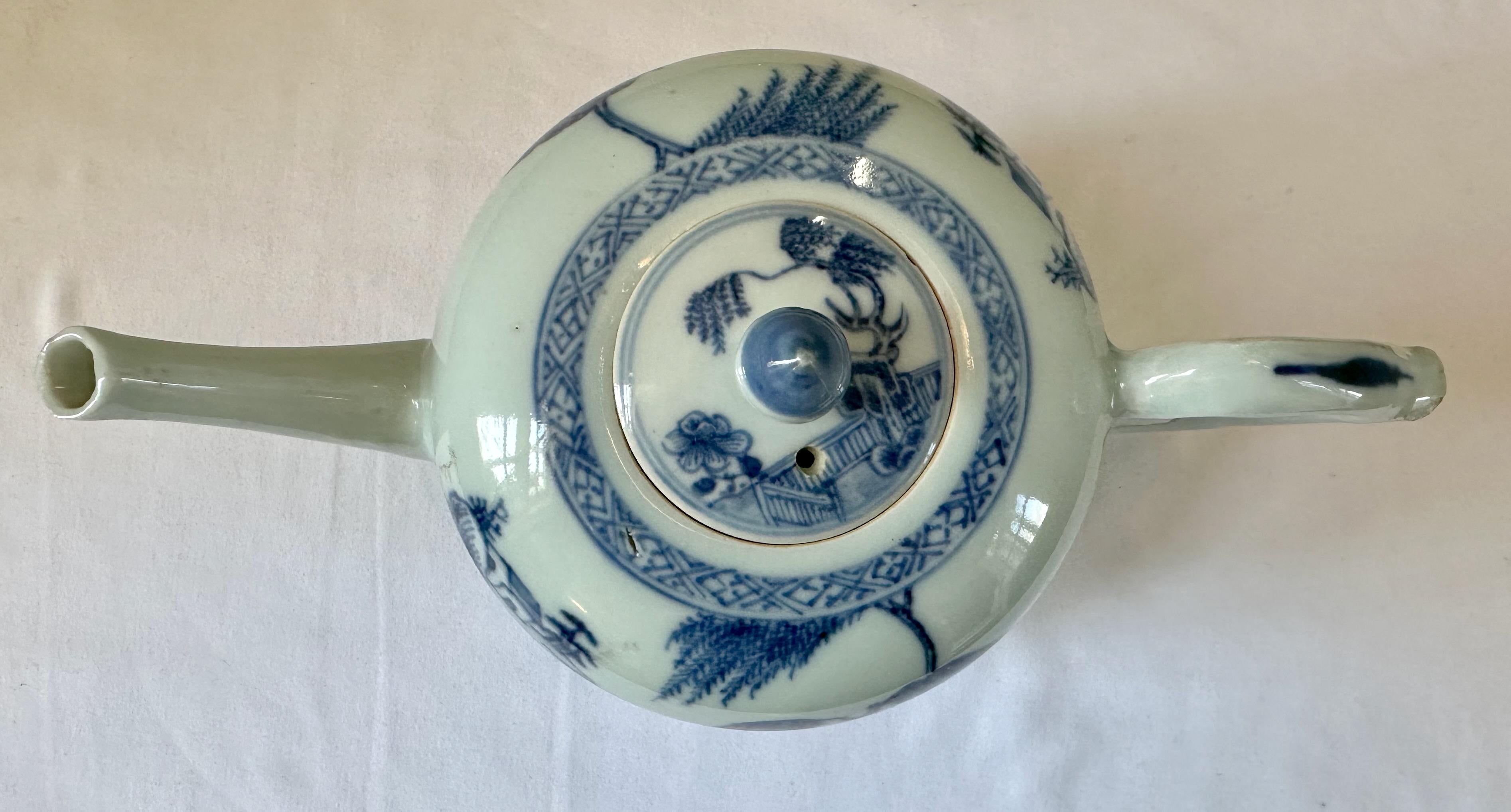 Blue and white teapot and cover from Nanking Cargo shipwreck, mid-18th century, painted with a willow tree on a fenced riverbank. The pattern is repeated on the cover. 

A large cache of porcelain and other merchandise was discovered on the wreck of