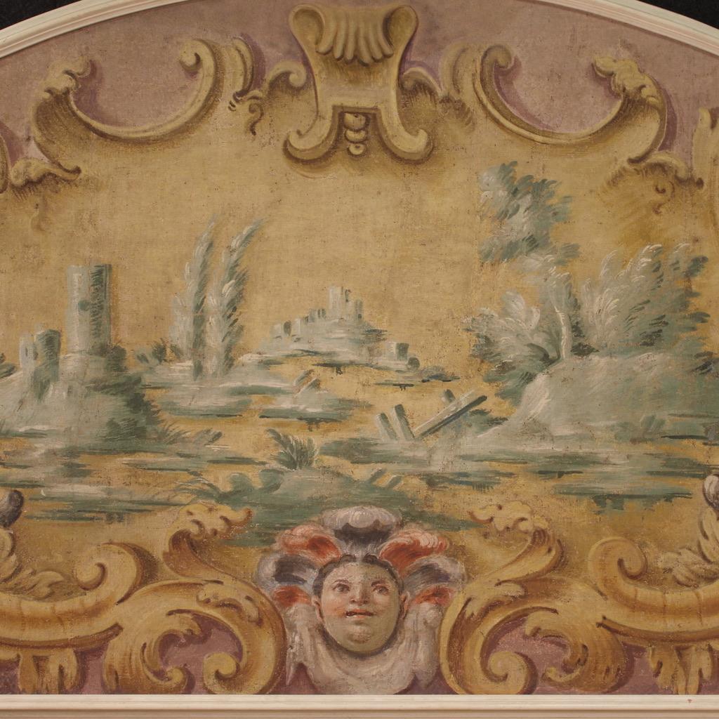 Antique Italian painting from the 18th century. Tempera artwork on canvas depicting a view with architecture, mask and lateral cornucopias of good pictorial quality. Painting of great size and impact adorned with a modern carved and painted wooden