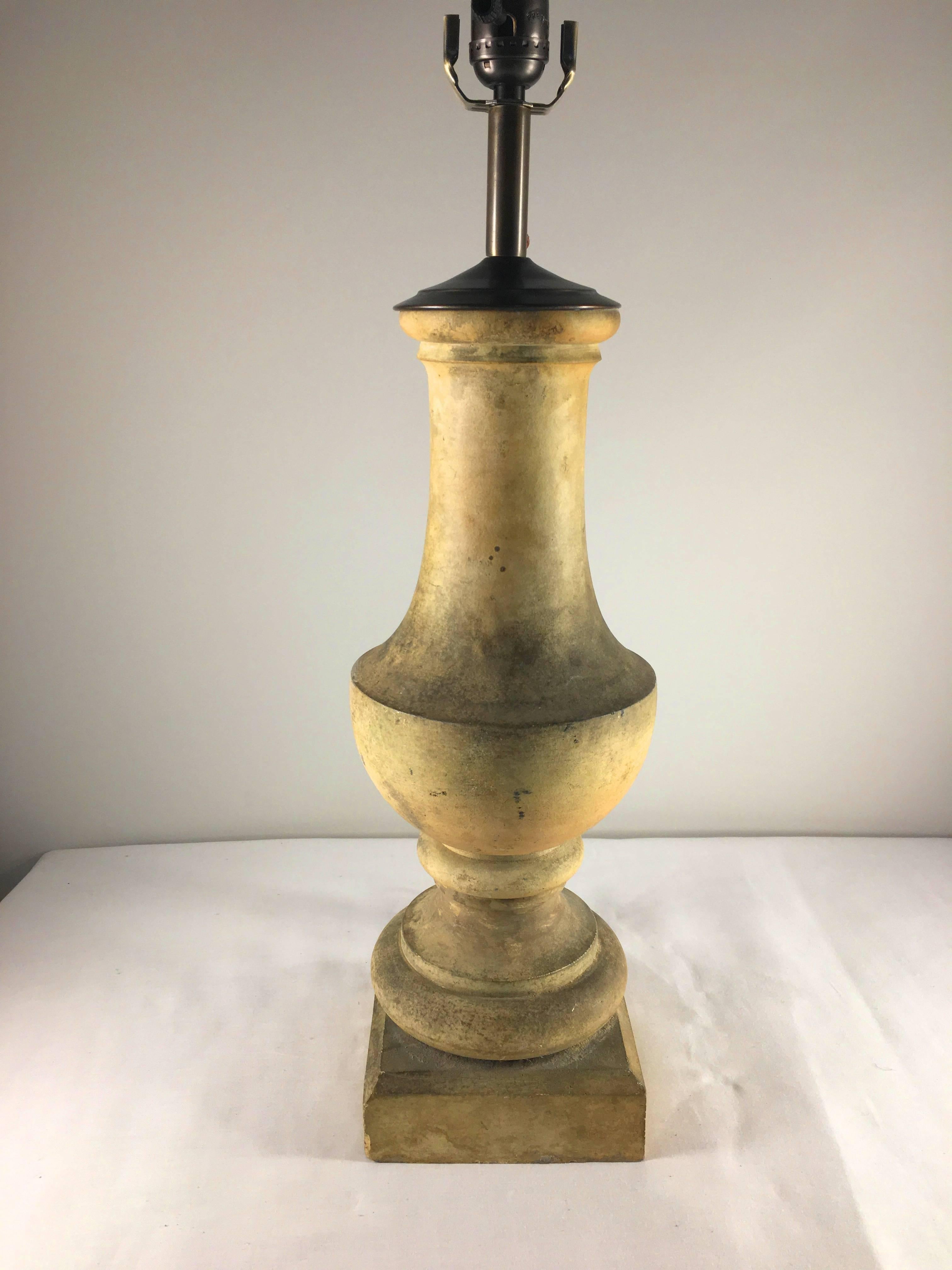 A French 18th century terracotta baluster mounted as a lamp with brass cap and fabric covered wire.